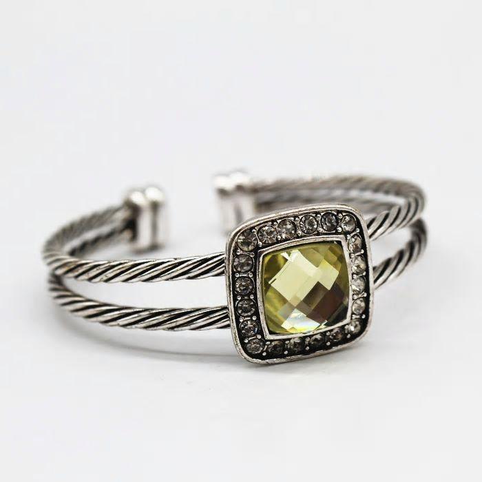Twisted Cable Cuff Bangle in silver with yellow Austrian crystal centerpiece, showcasing intricate twisted design and smaller surrounding crystals.
