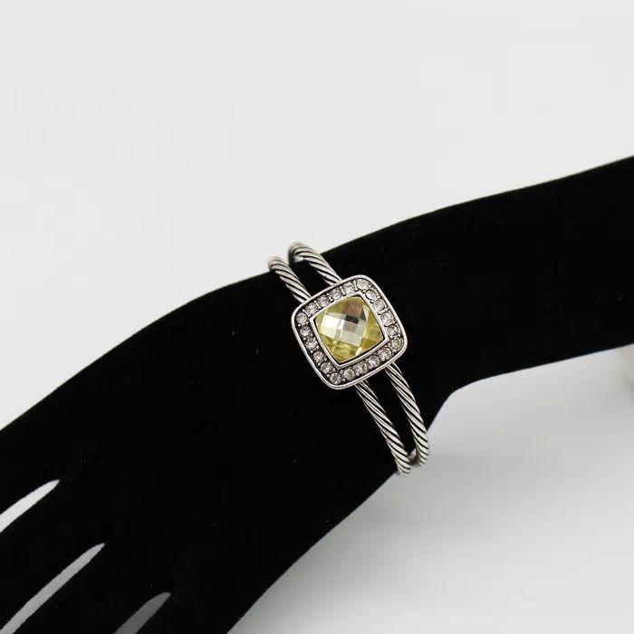 Twisted Cable Cuff Bangle in silver with yellow Austrian crystal centerpiece, showcasing intricate twisted design and smaller surrounding crystals.