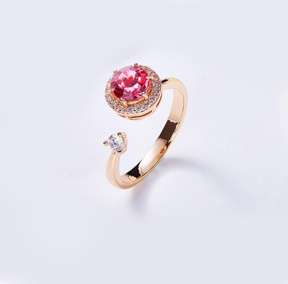 Twisted Pink Austrian Elements Circular Halo Adjustable Ring featuring 14K rose gold plating and pink stones, elegantly designed for comfort.