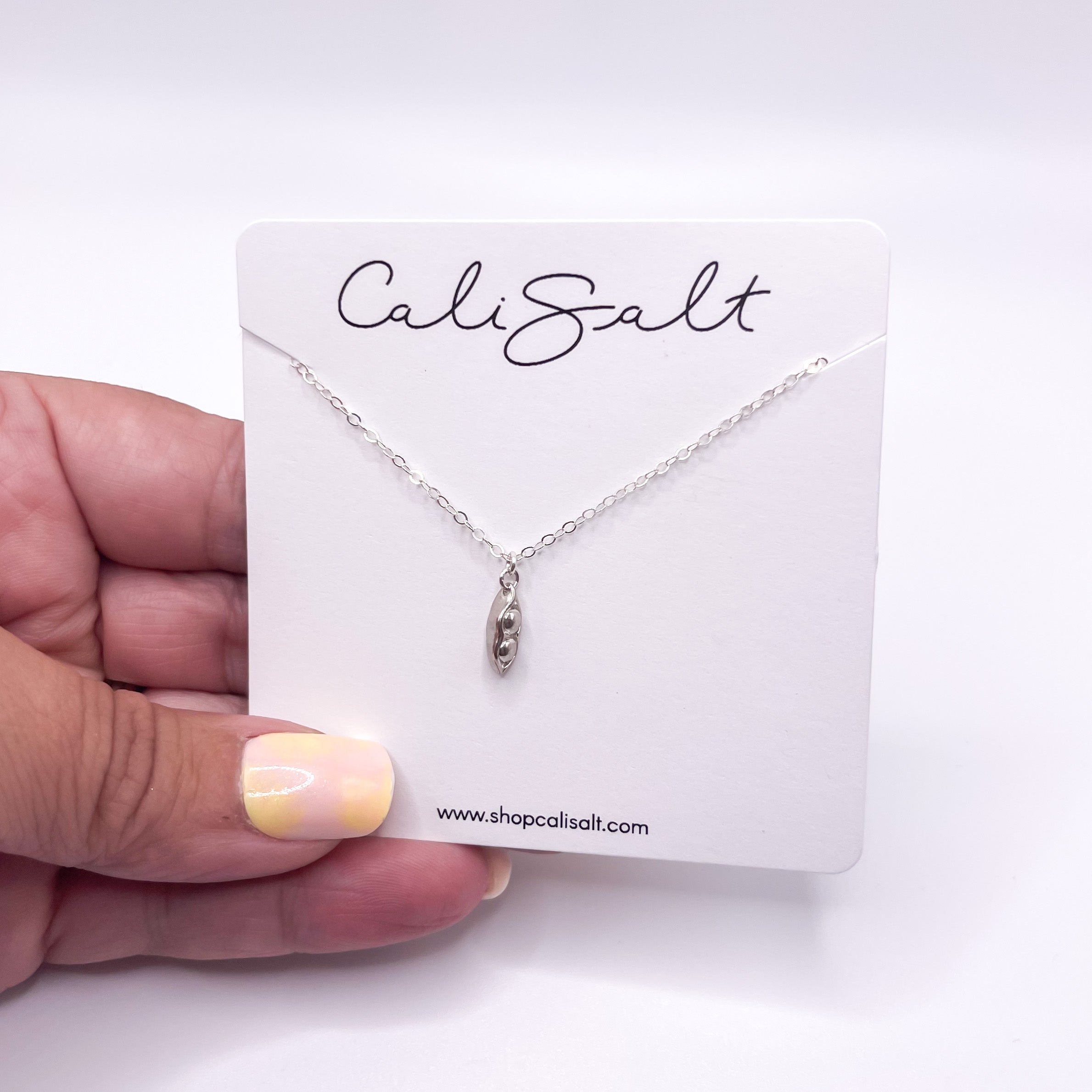 Two Peas in a Pod Necklace in gold fill and sterling silver, symbolizing friendship and connection.