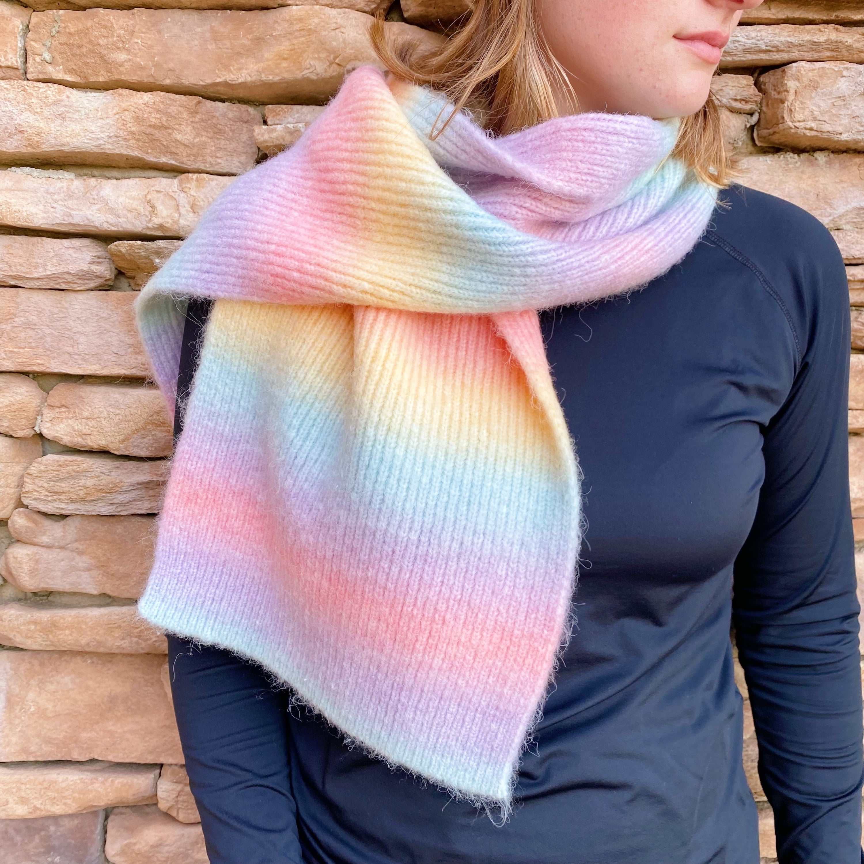 A vibrant Unicorn In My Dream Cozy Knit Scarf featuring a colorful knit pattern, perfect for adding warmth and style.