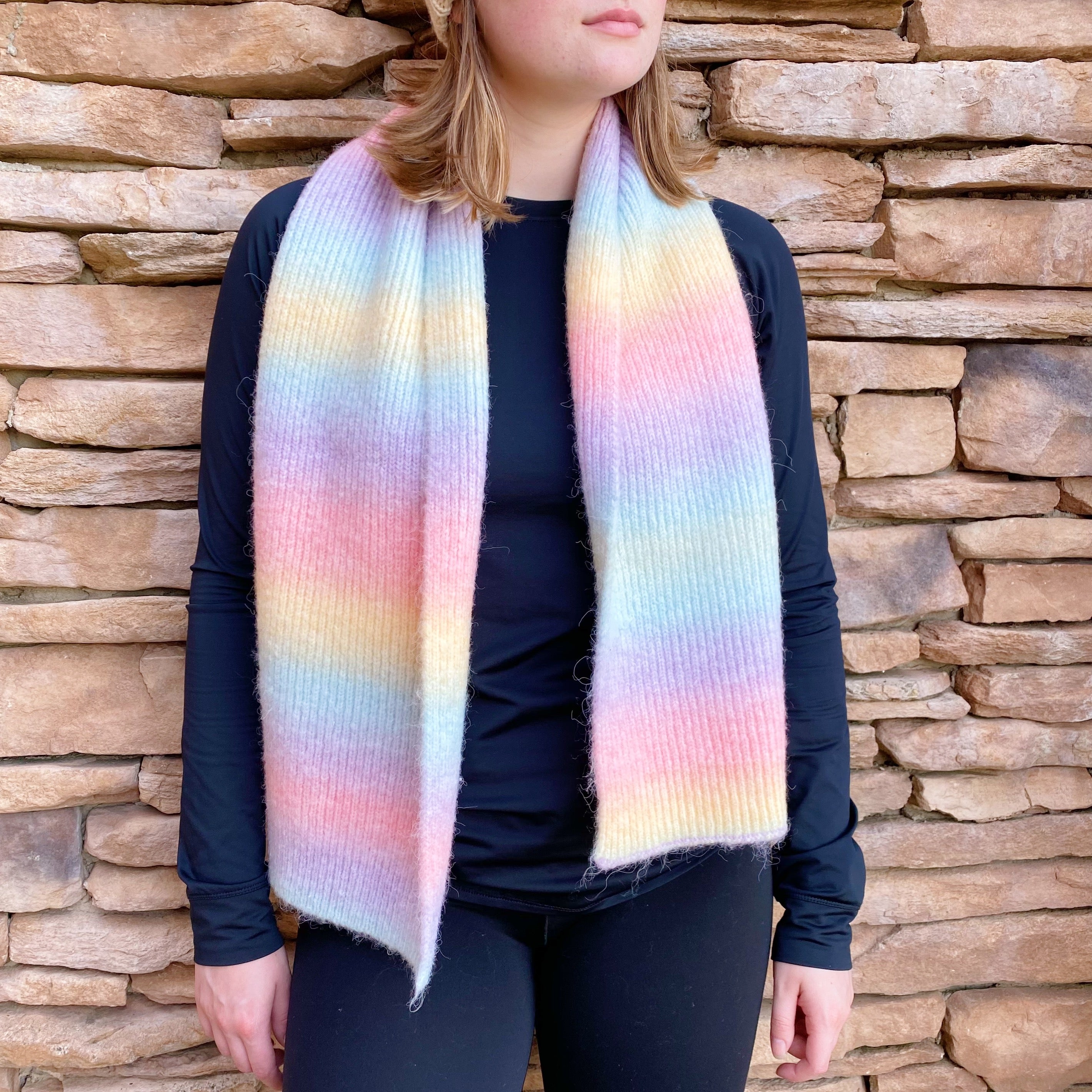 A vibrant Unicorn In My Dream Cozy Knit Scarf featuring a colorful knit pattern, perfect for adding warmth and style.