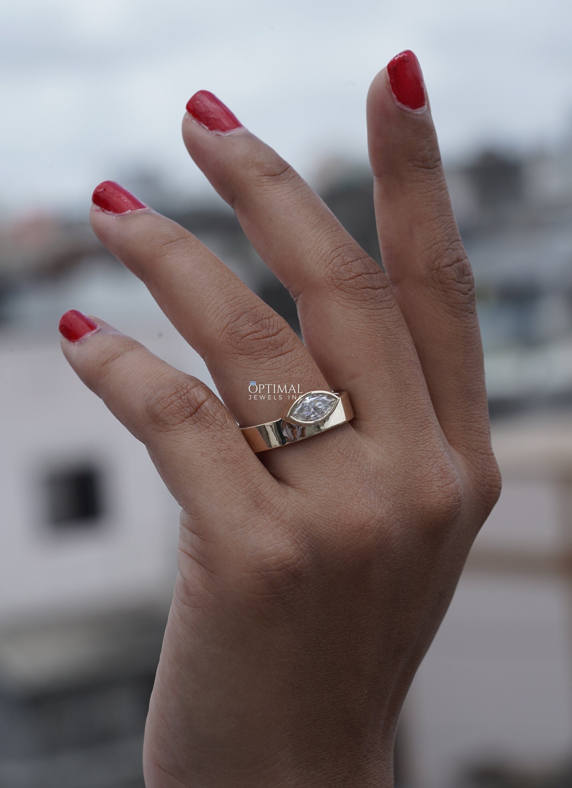 Unique 1.00 CTW Lab Grown Diamond Ring featuring a marquise cut diamond set in an 18K yellow gold bezel, perfect for engagements or anniversaries.