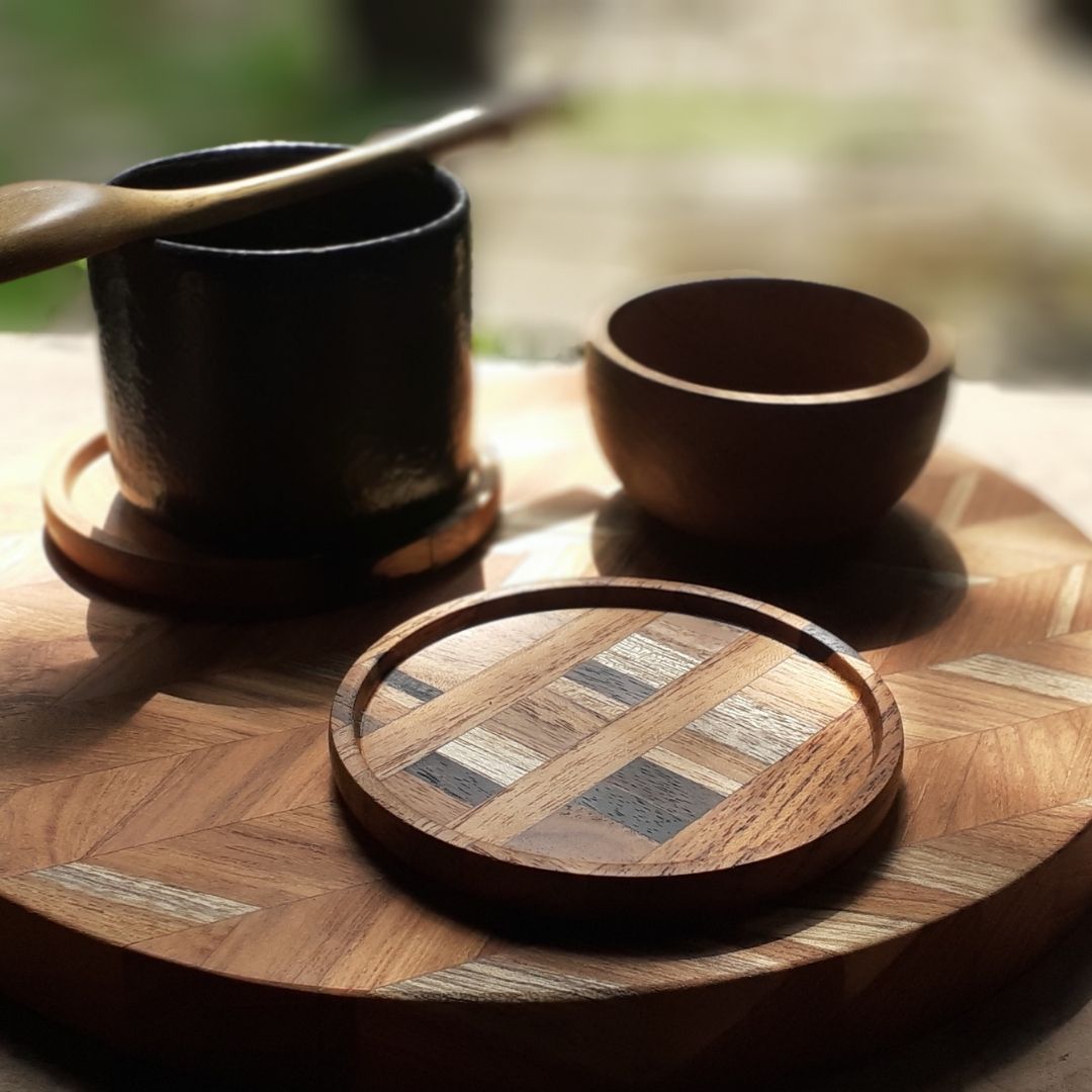 A set of unique handmade end grain wooden coasters made from reclaimed teak and rosewood, showcasing rich grain patterns and deep tones.