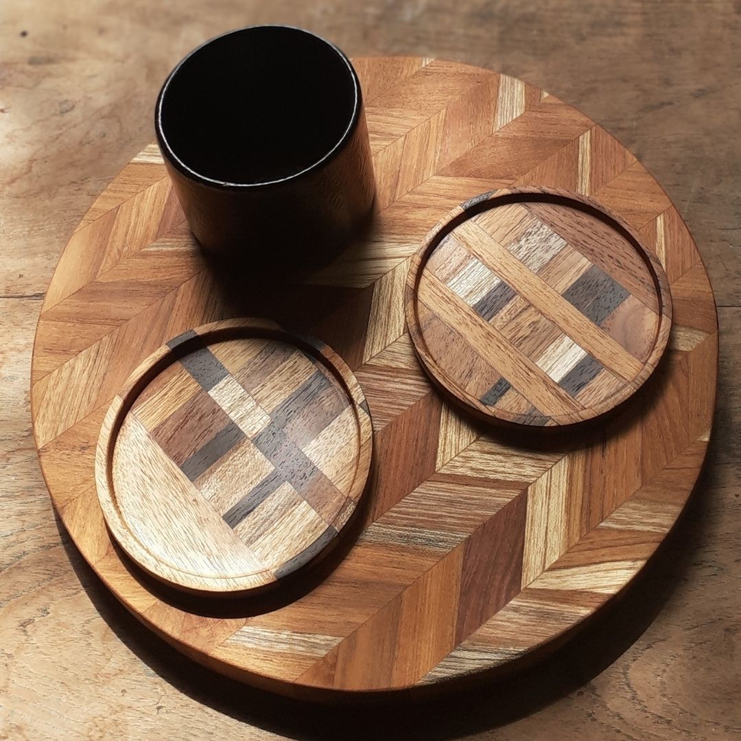 A set of unique handmade end grain wooden coasters made from reclaimed teak and rosewood, showcasing rich grain patterns and deep tones.