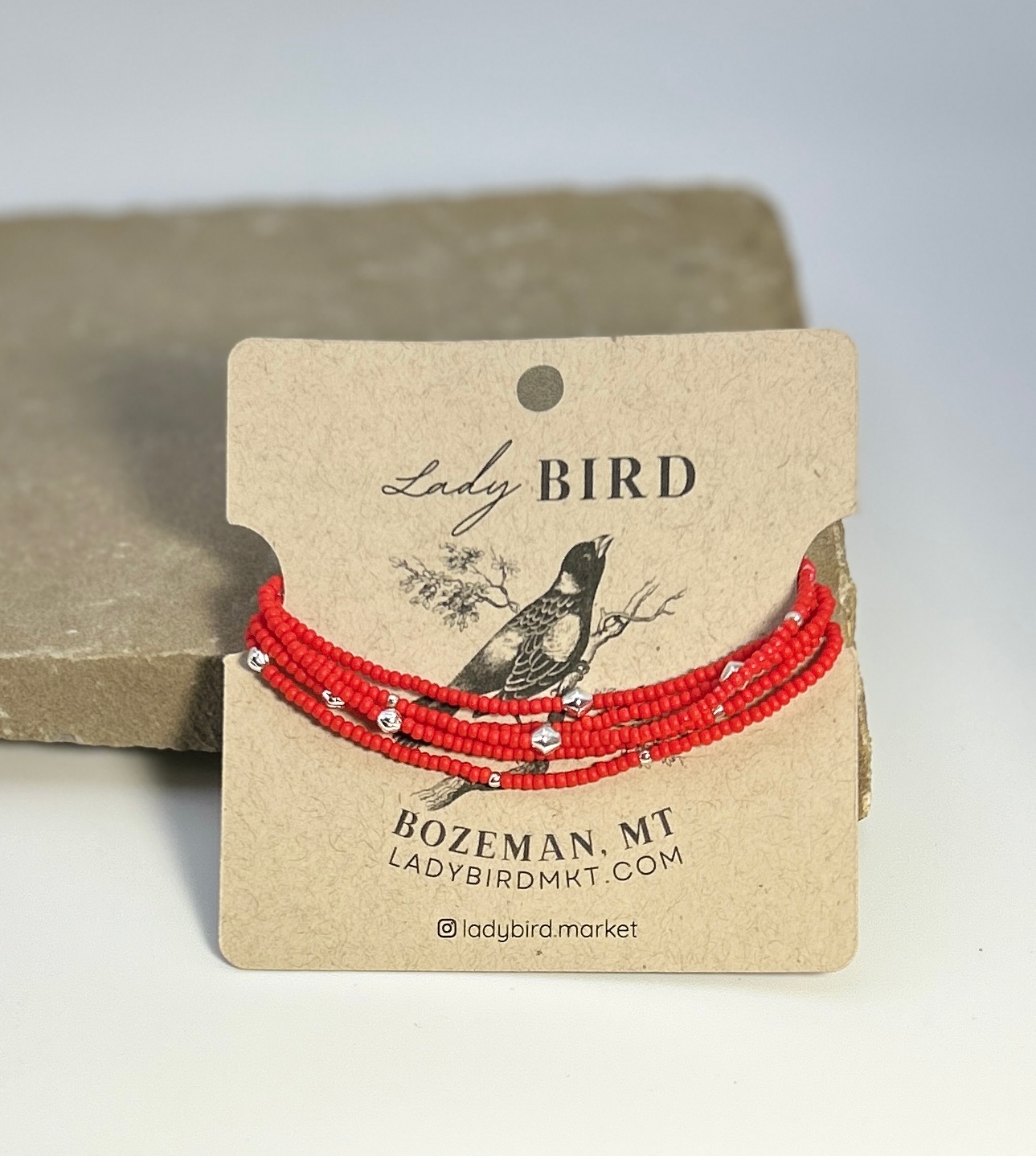 Vibrant bright red beaded boho wrap bracelet with silver and gold accents, showcasing a stylish design perfect for stacking or solo wear.