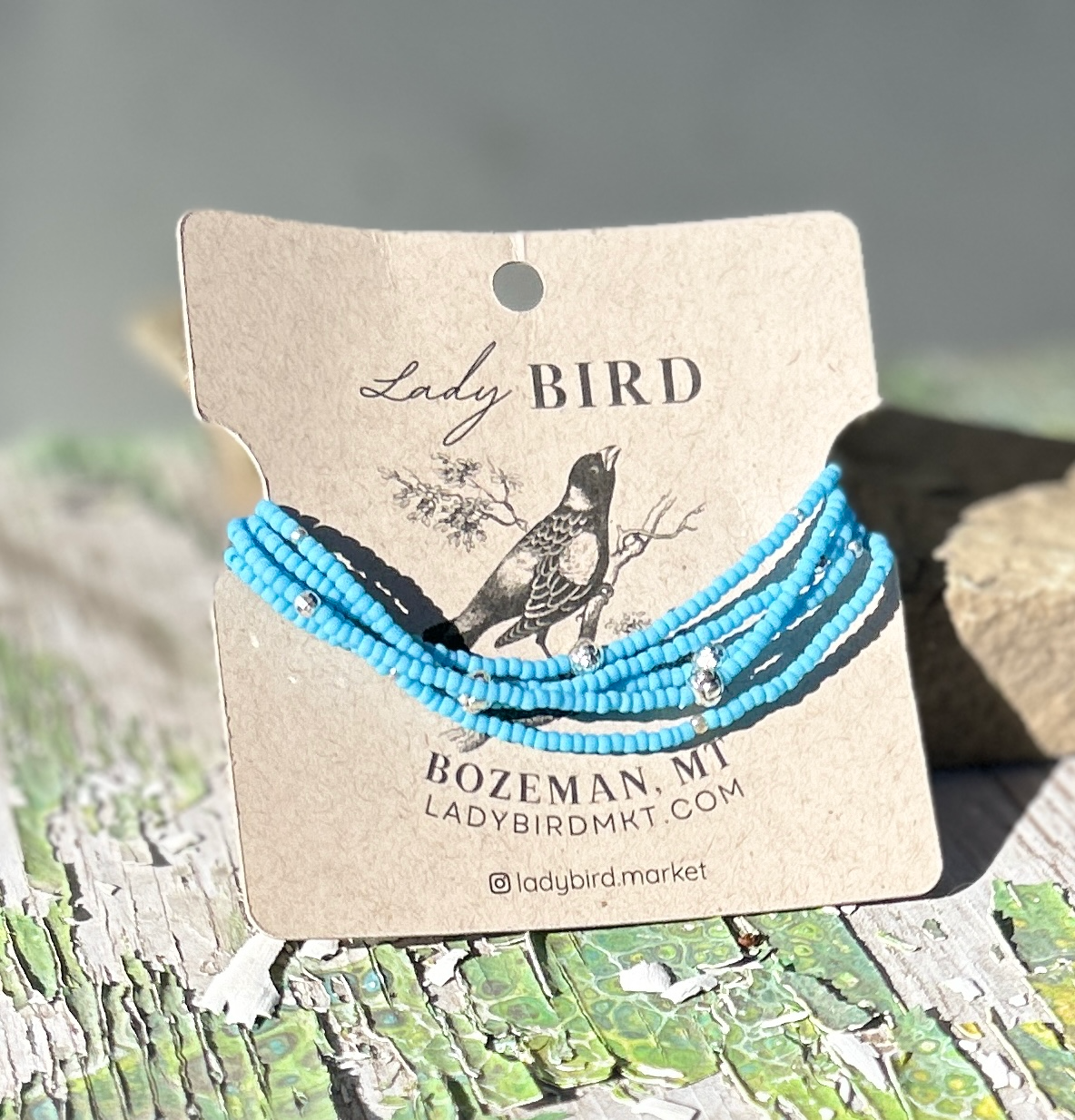 Vibrant light blue beaded boho wrap bracelet with silver-sprinkled beads, showcasing its unique design and handcrafted quality.