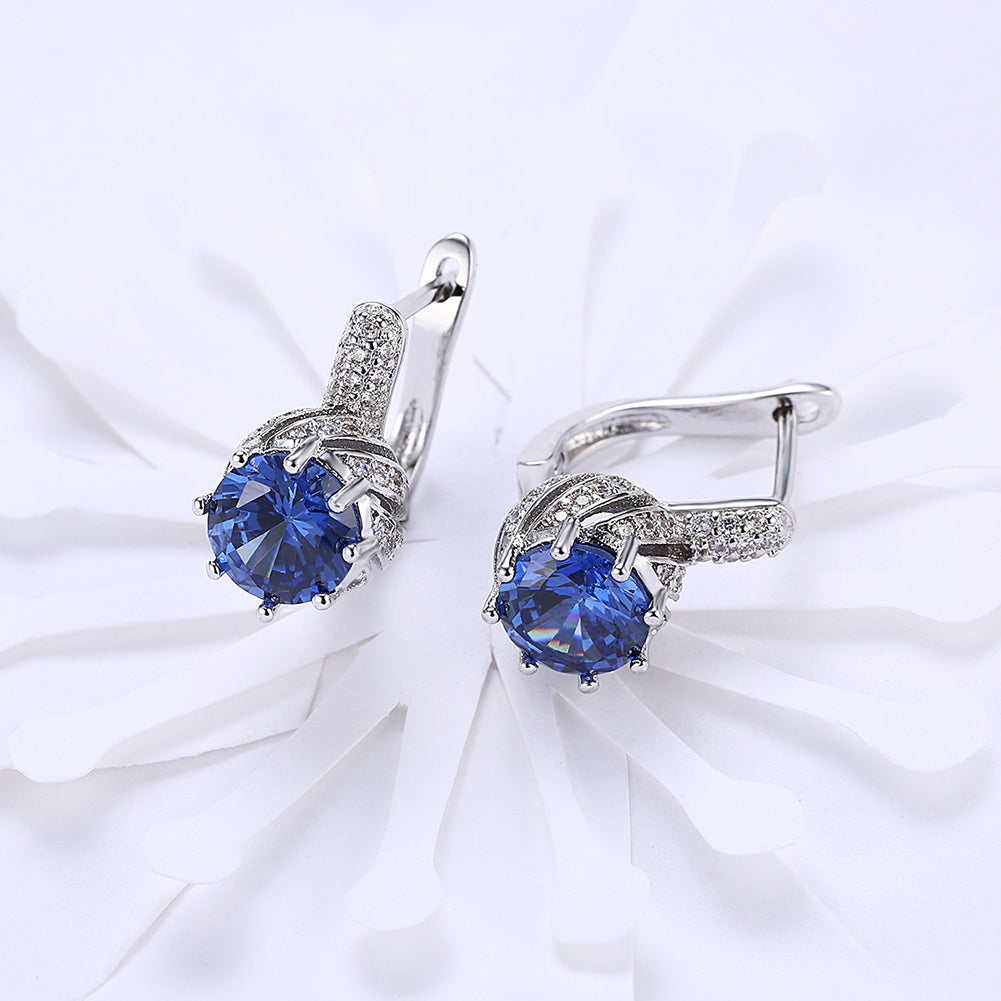 Vienna 1.00 Ct Sapphire Round Cut Huggie Earring in 18K White Gold, showcasing brilliant sapphires and elegant design.