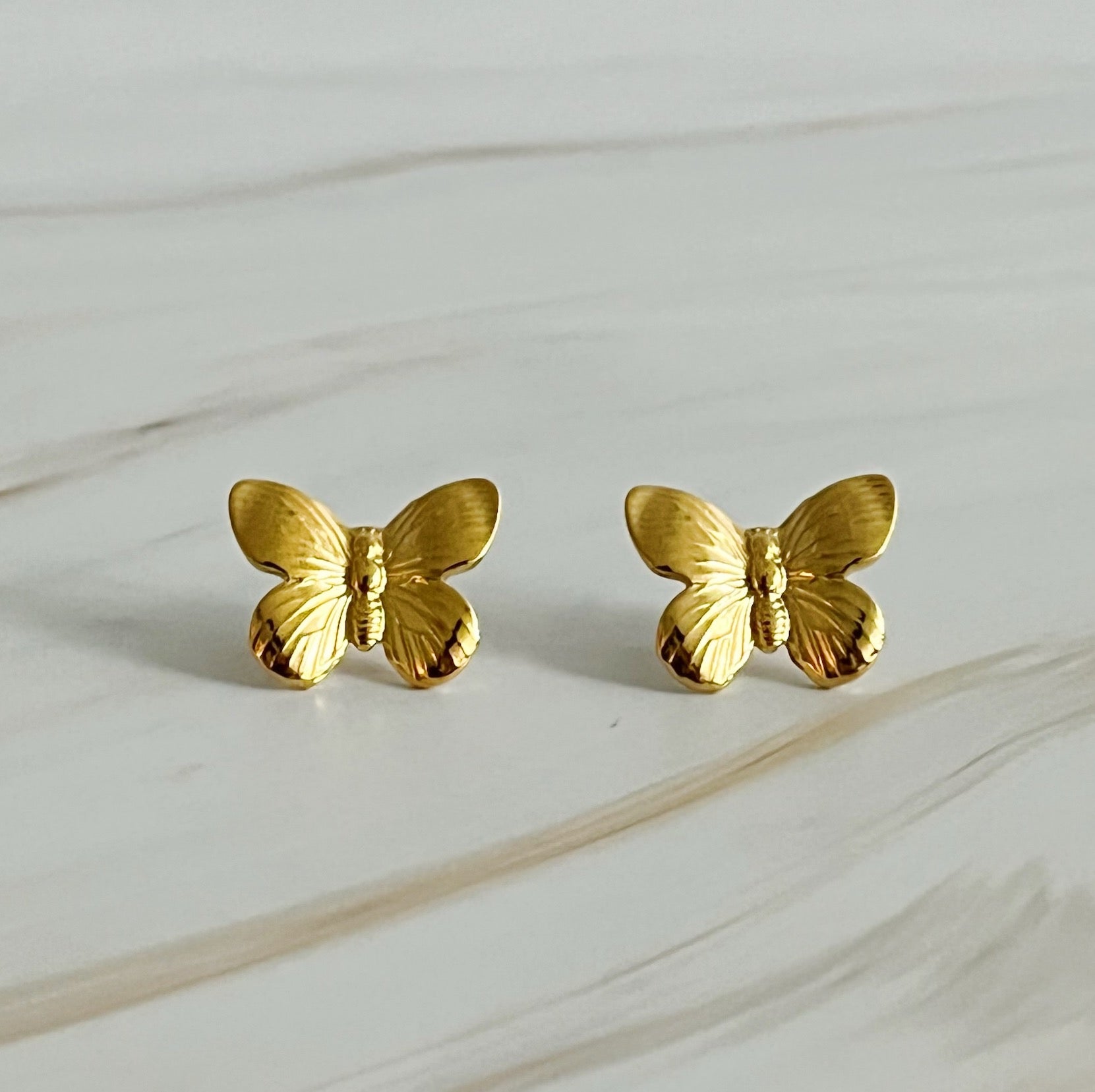 A pair of Vintage Butterfly Solo Stud Earrings featuring intricate butterfly design in 18k gold plated stainless steel.