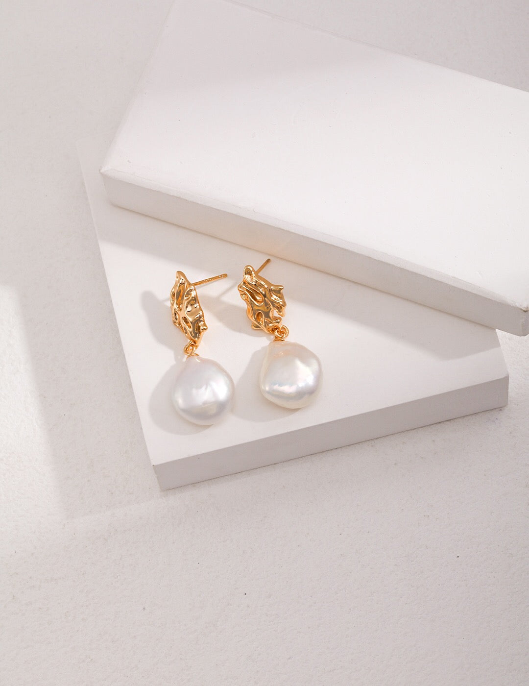 Elegant vintage-inspired pearl drop earrings featuring natural freshwater pearls and sterling silver, perfect for any occasion.