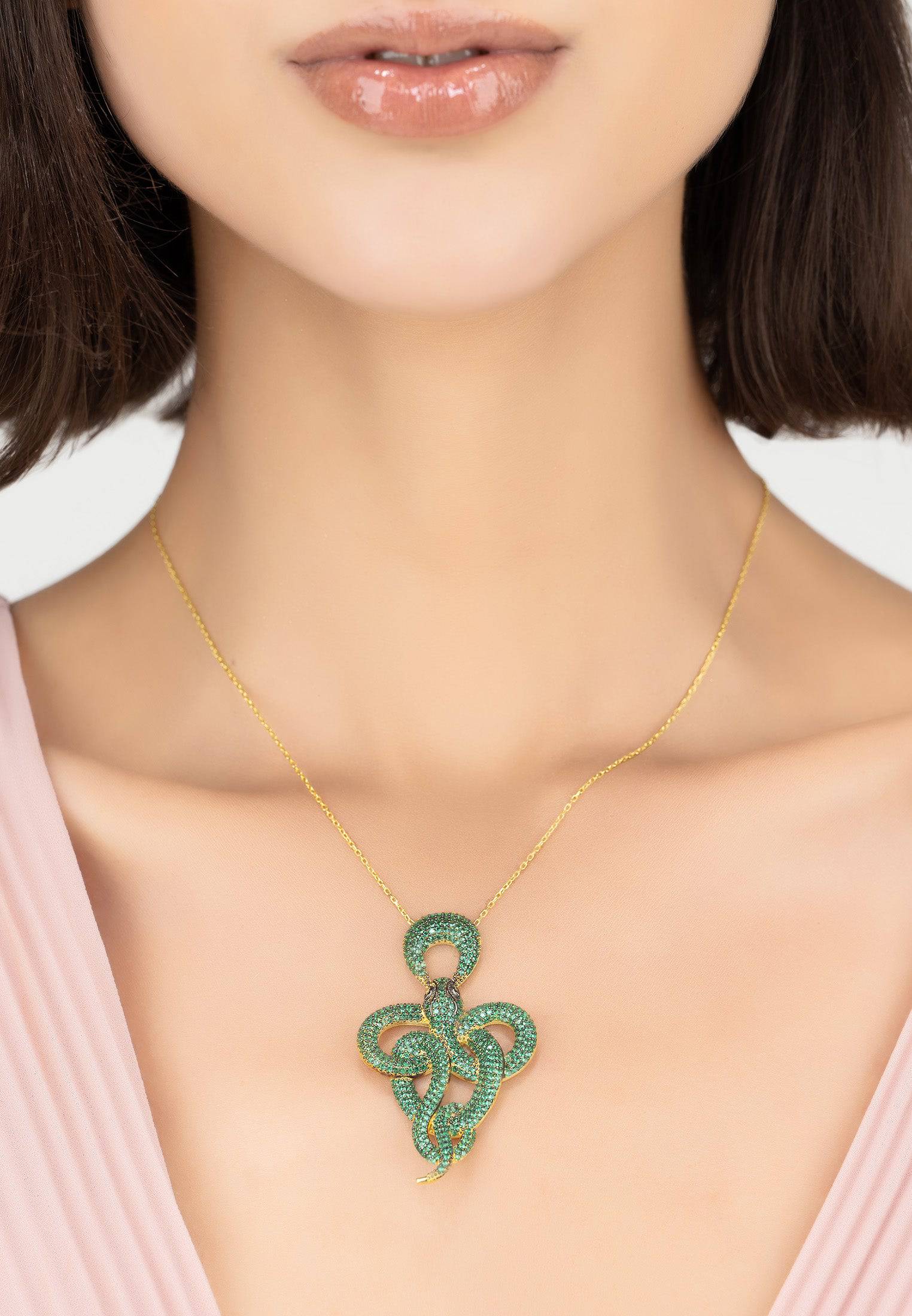 Viper Snake Pendant Necklace in gold with emerald zircons, featuring a snake motif and adjustable length.