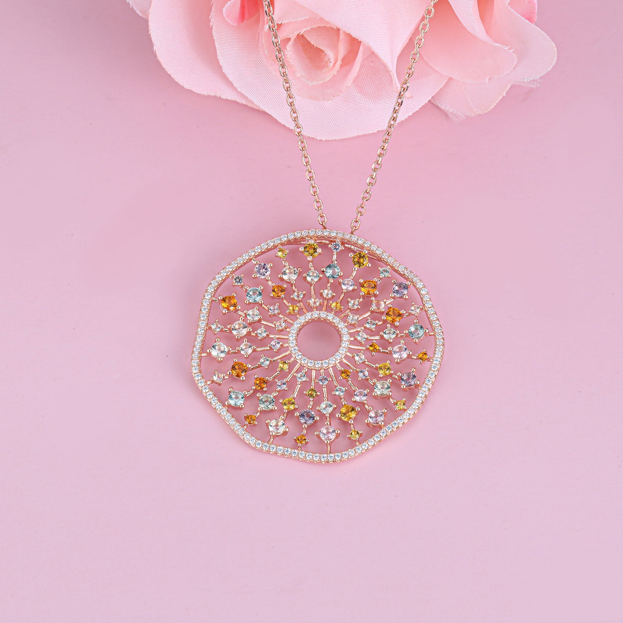A stunning rose gold plarty necklace featuring colorful gemstones including white sapphire, amethyst, peridot, garnet, citrine, and tourmaline, perfect for special occasions.