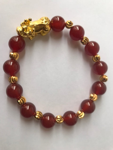 Wealth & Abundance Red Agate Bracelet featuring genuine crystals on a stretch cord, symbolizing healing and prosperity.