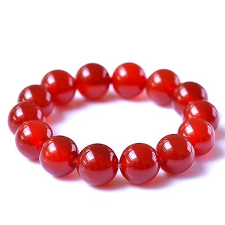 Wealth & Abundance Red Agate Bracelet featuring genuine crystals on a stretch cord, symbolizing healing and prosperity.