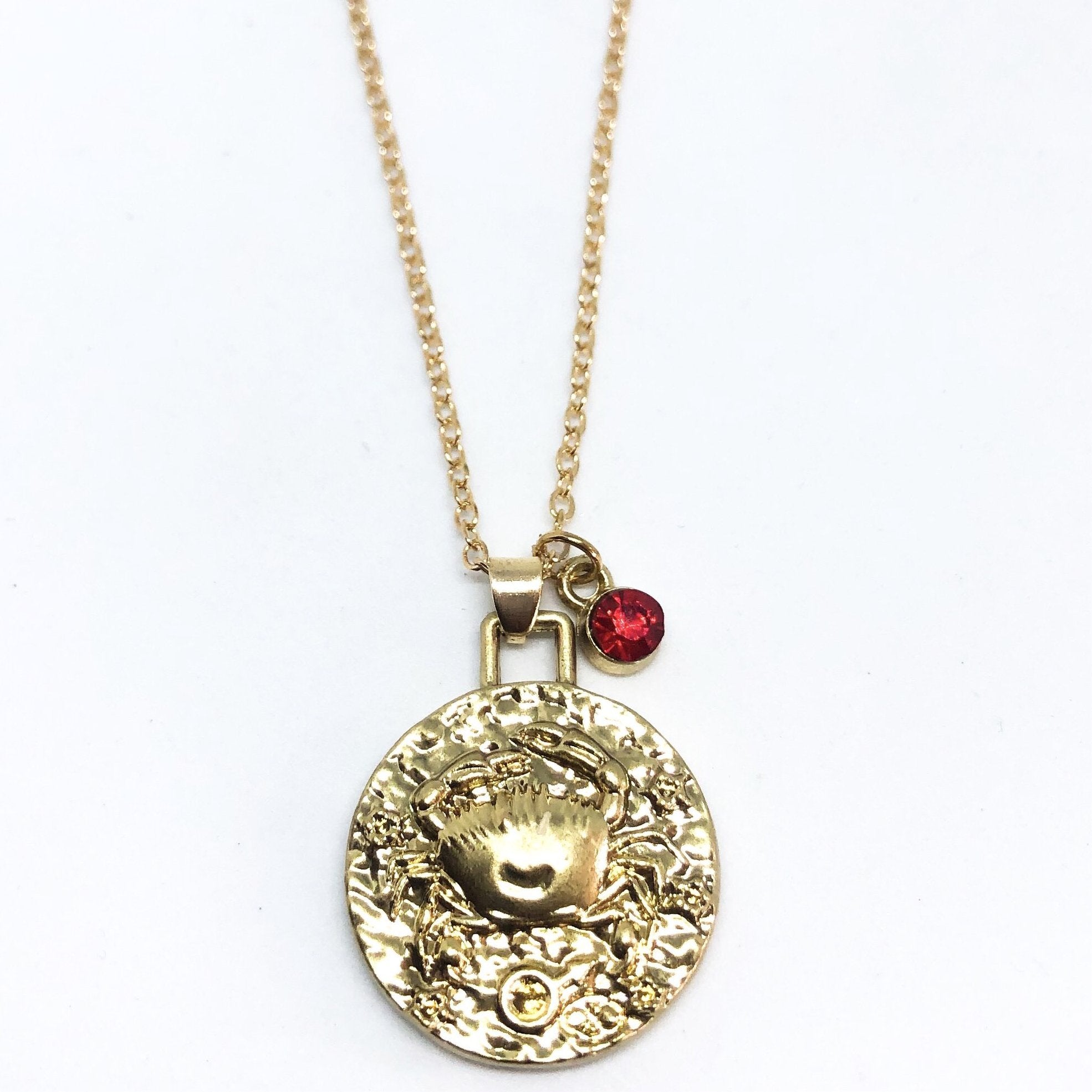 A beautiful 24K gold plated zodiac necklace featuring a double-sided pendant with astrological sign on one side and zodiac sign stamped on the other.