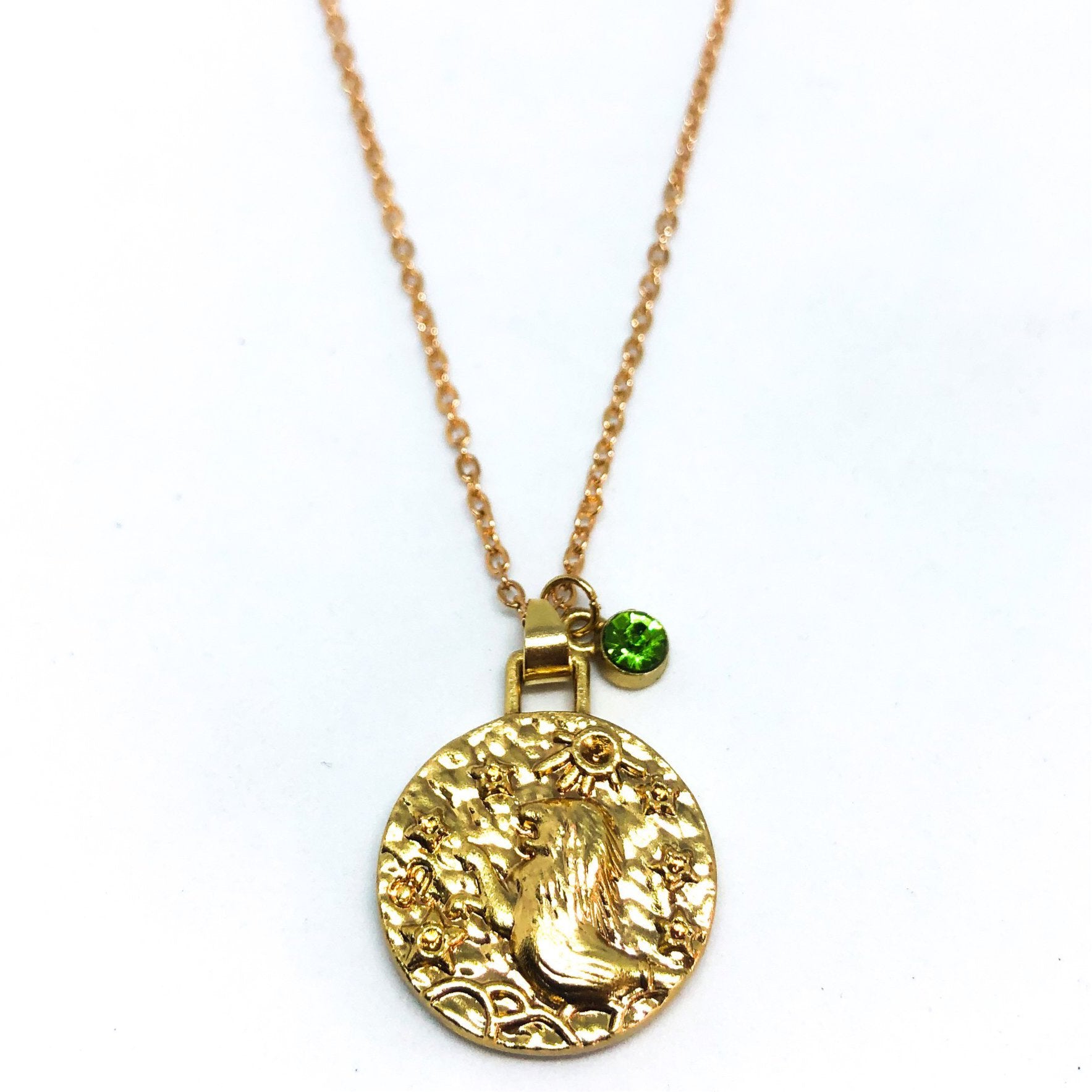 A beautiful 24K gold plated zodiac necklace featuring a double-sided pendant with astrological sign on one side and zodiac sign stamped on the other.