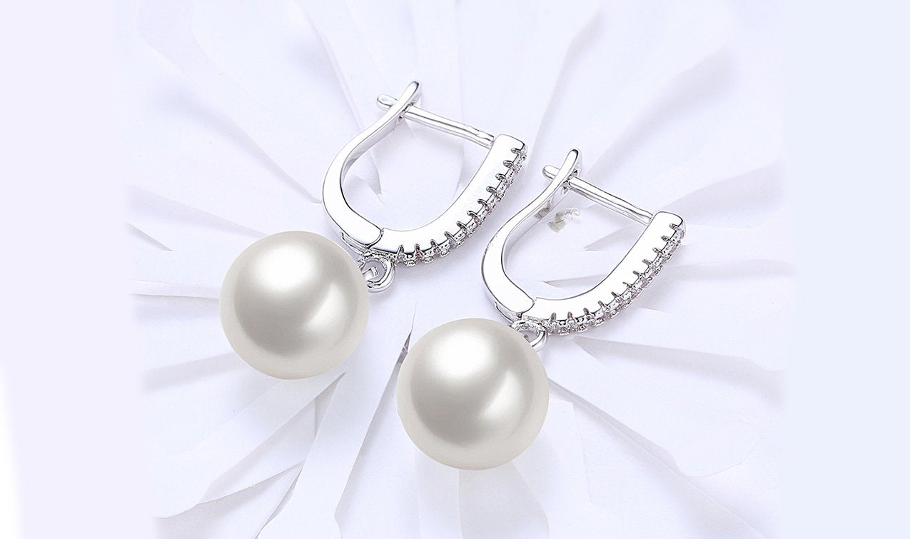Elegant White Austrian Elements Thin Dangling Freshwater Pearl Clip On Earrings featuring 14K white gold plating and AAAAA quality stones.