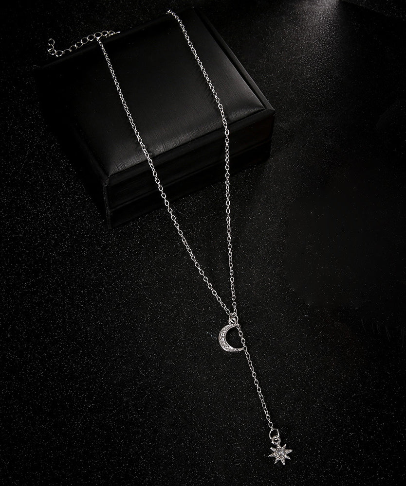 Elegant White Crystal Pav'e Star & Moon Lariat Necklace in 14K White Gold Plat featuring a star and moon pendant with sparkling AAAAA crystals.