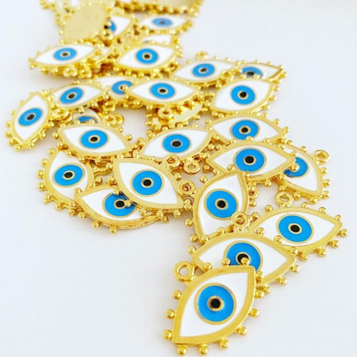 A beautiful White Evil Eye Charm featuring an enamel bead design with a gold evil eye pendant, perfect for jewelry making.