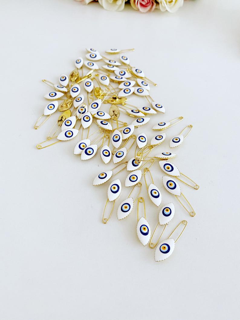 White Evil Eye Safety Pin featuring a brass design with an 8mm evil eye charm, perfect for weddings and baby showers.