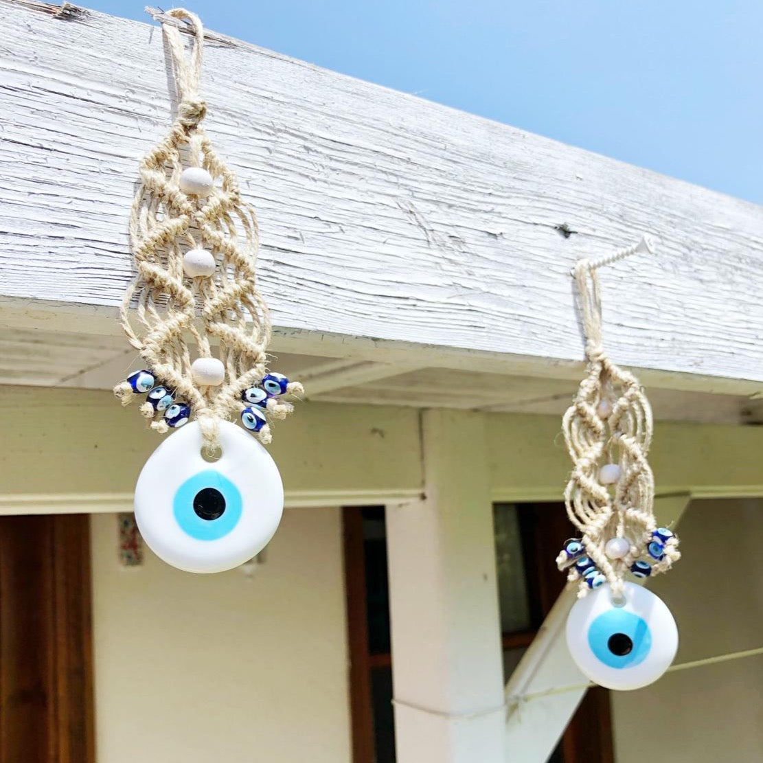 A beautiful white evil eye wall hanging ornament, featuring a large white bead symbolizing protection, perfect for Christmas tree decoration.