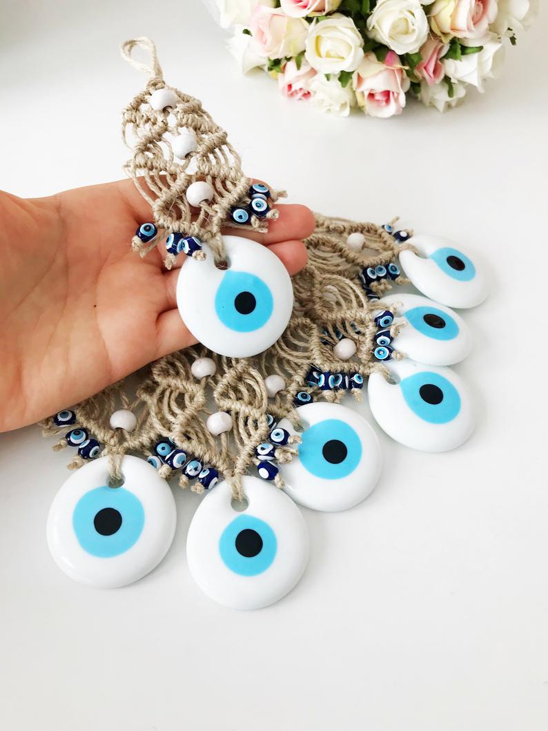 A beautiful white evil eye wall hanging ornament, featuring a large white bead symbolizing protection, perfect for Christmas tree decoration.