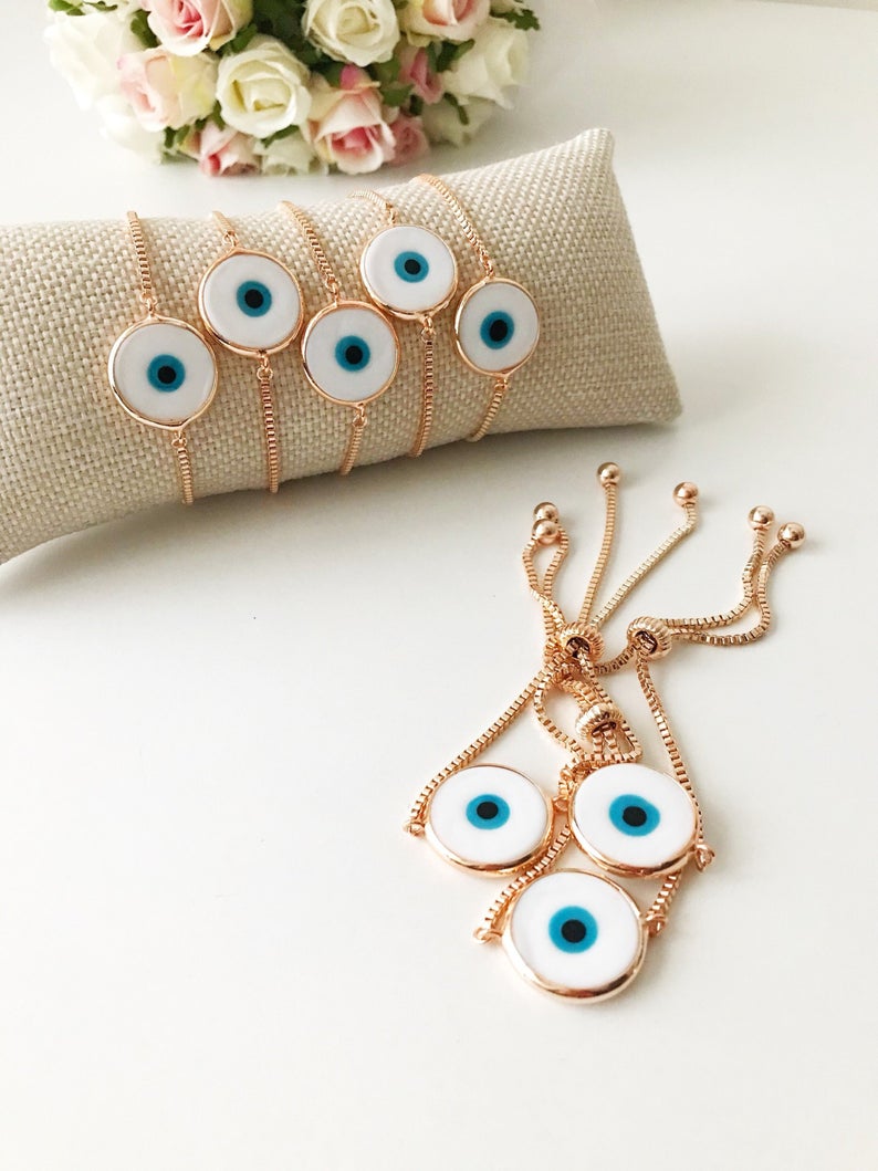 A beautiful White Murano Evil Eye Bracelet featuring a handmade Murano glass charm on an adjustable rose gold chain, showcasing elegance and durability.