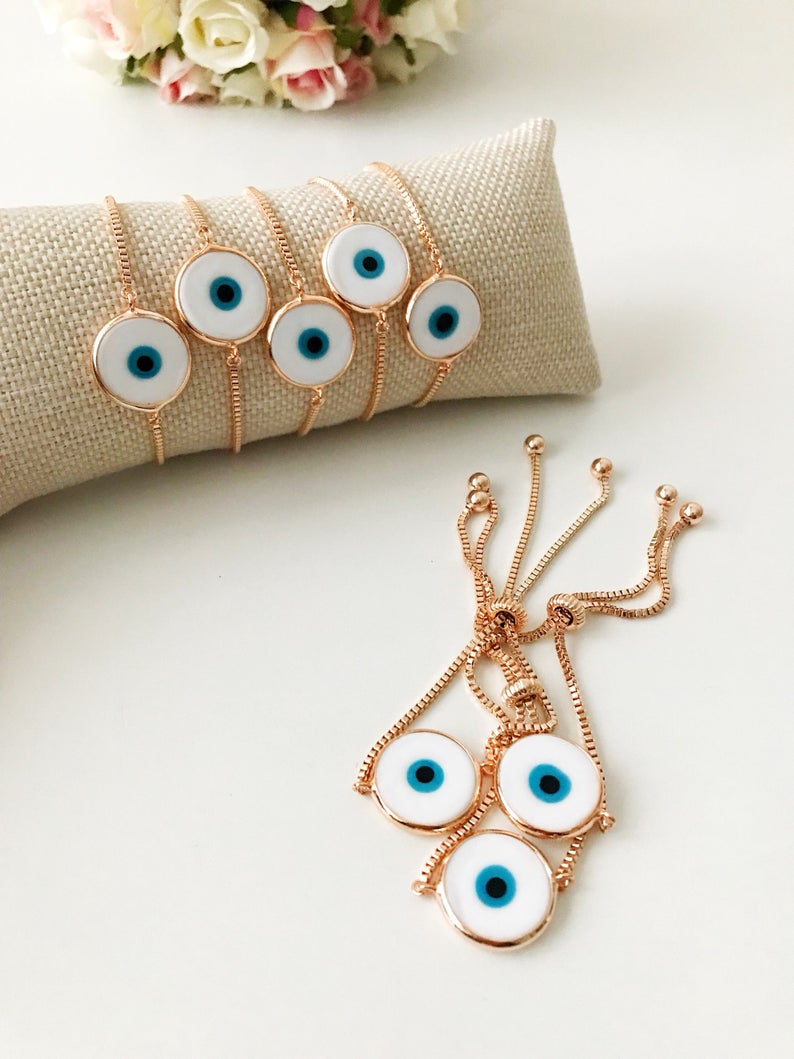 A beautiful White Murano Evil Eye Bracelet featuring a handmade Murano glass charm on an adjustable rose gold chain, showcasing elegance and durability.
