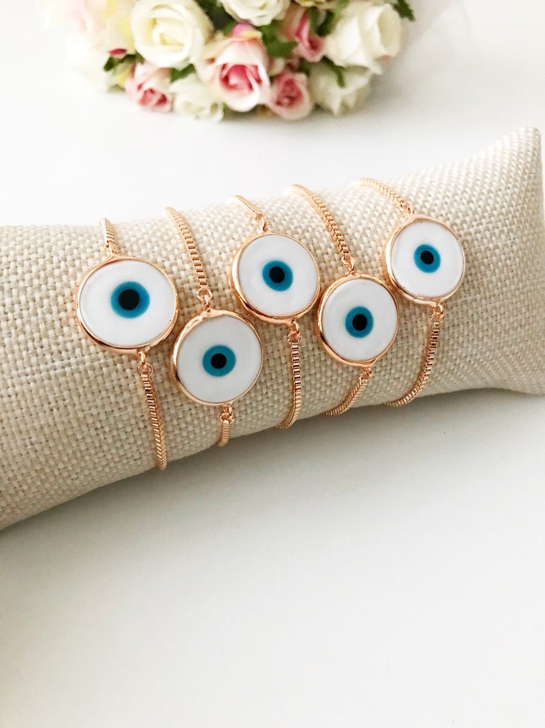 A beautiful White Murano Evil Eye Bracelet featuring a handmade Murano glass charm on an adjustable rose gold chain, showcasing elegance and durability.