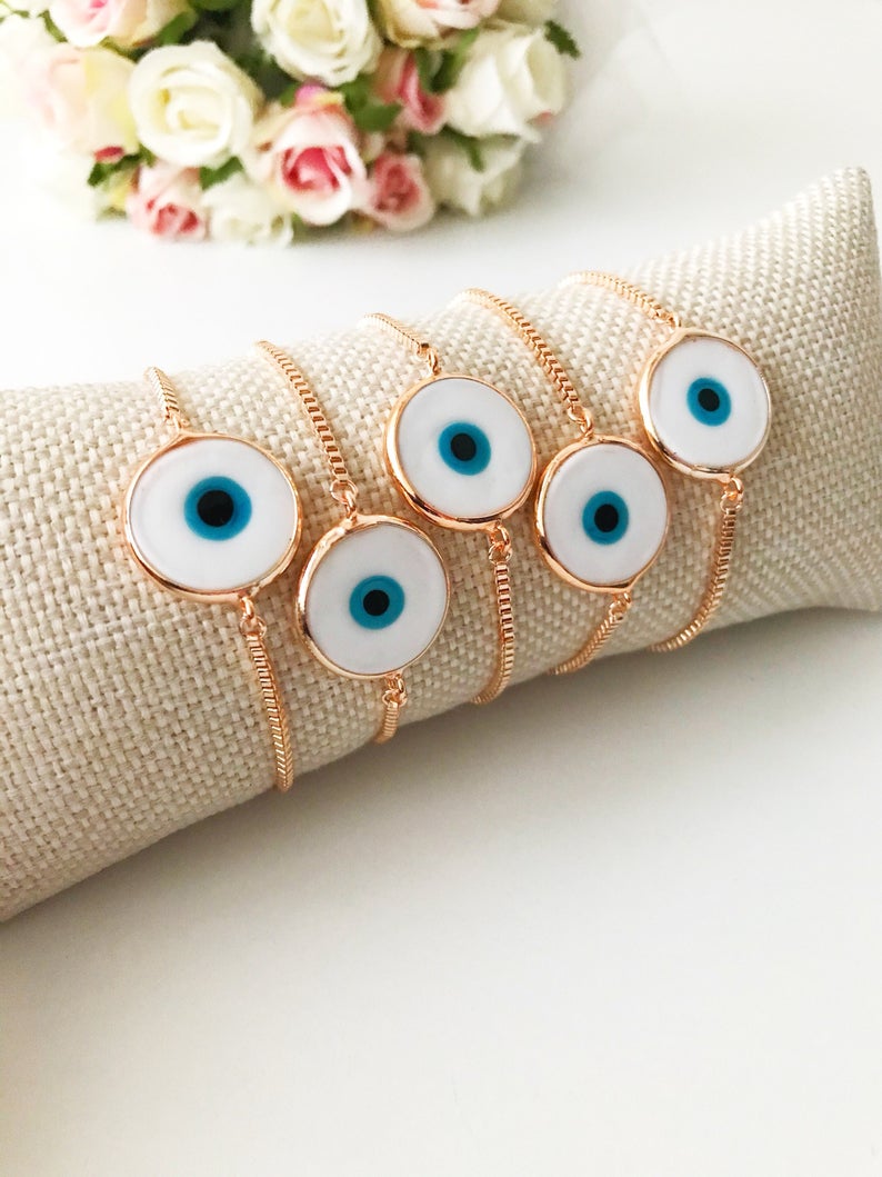 A beautiful White Murano Evil Eye Bracelet featuring a handmade Murano glass charm on an adjustable rose gold chain, showcasing elegance and durability.