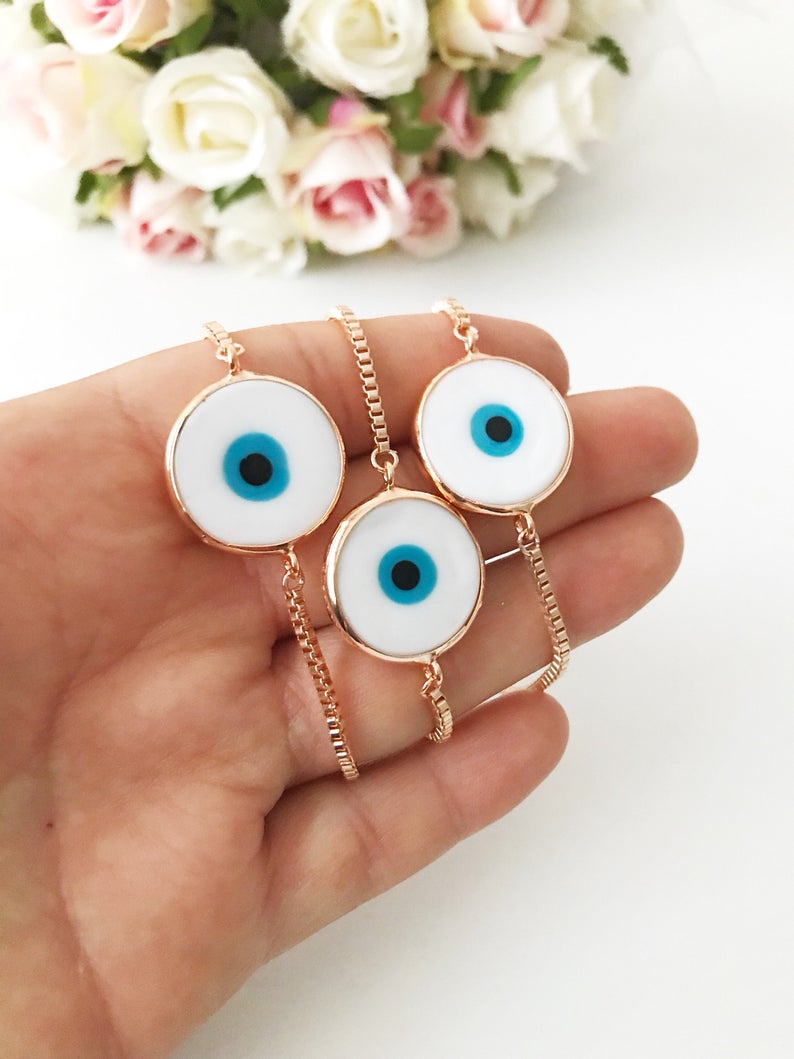 A beautiful White Murano Evil Eye Bracelet featuring a handmade Murano glass charm on an adjustable rose gold chain, showcasing elegance and durability.