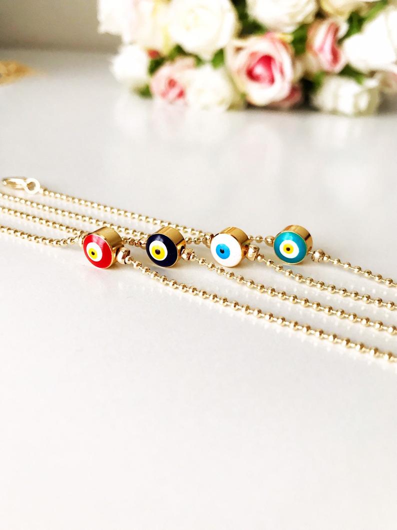 Wholesale Evil Eye Bracelet featuring blue beads and a gold chain, symbolizing protection and good luck.
