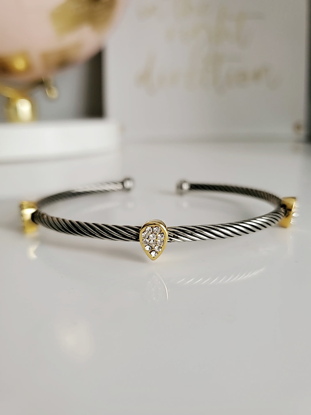Wide Cable Bangle with Drop Accents featuring stainless steel and gold-filled materials, showcasing a modern design with elegant drop accents.