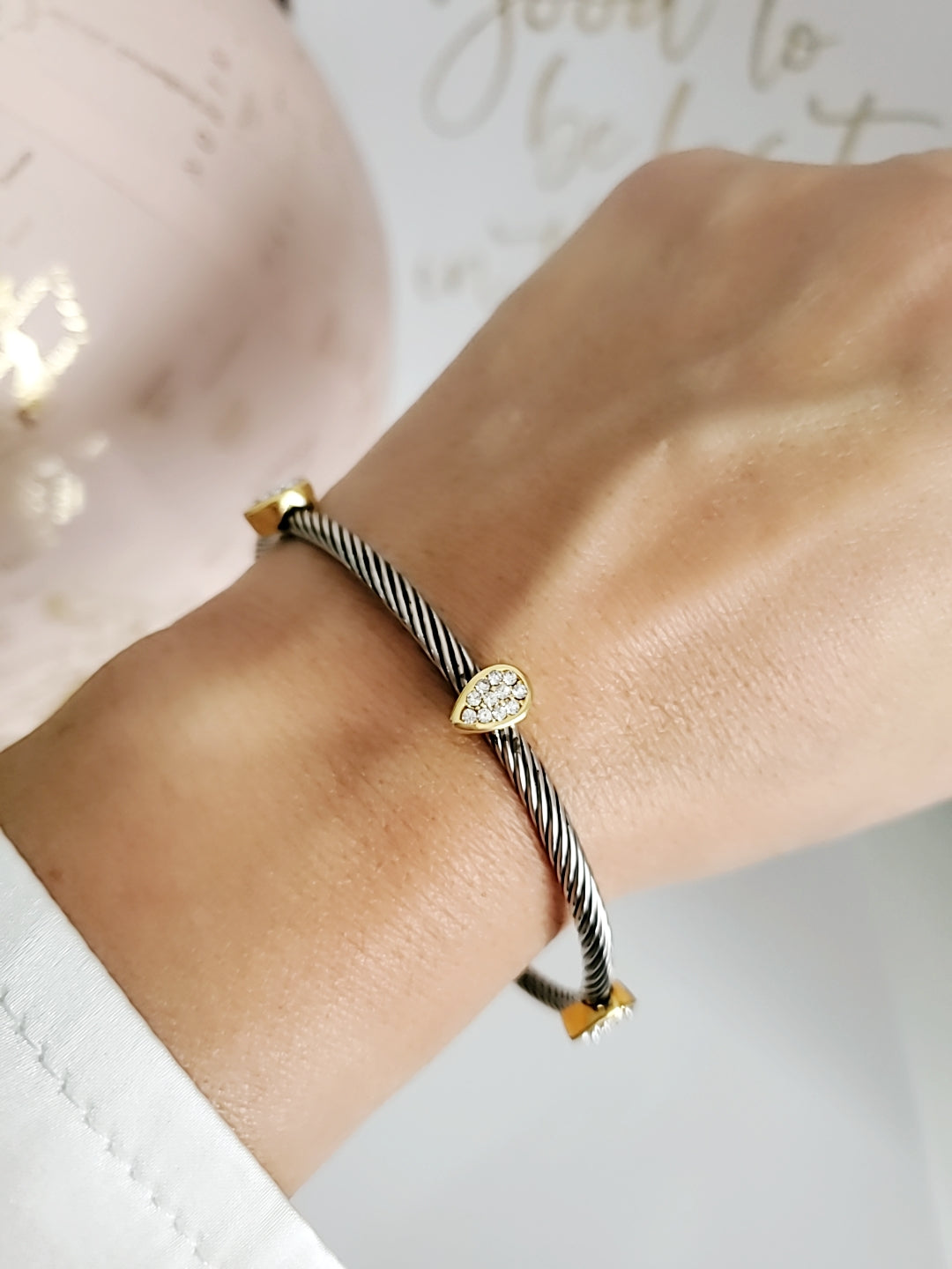 Wide Cable Bangle with Drop Accents featuring stainless steel and gold-filled materials, showcasing a modern design with elegant drop accents.