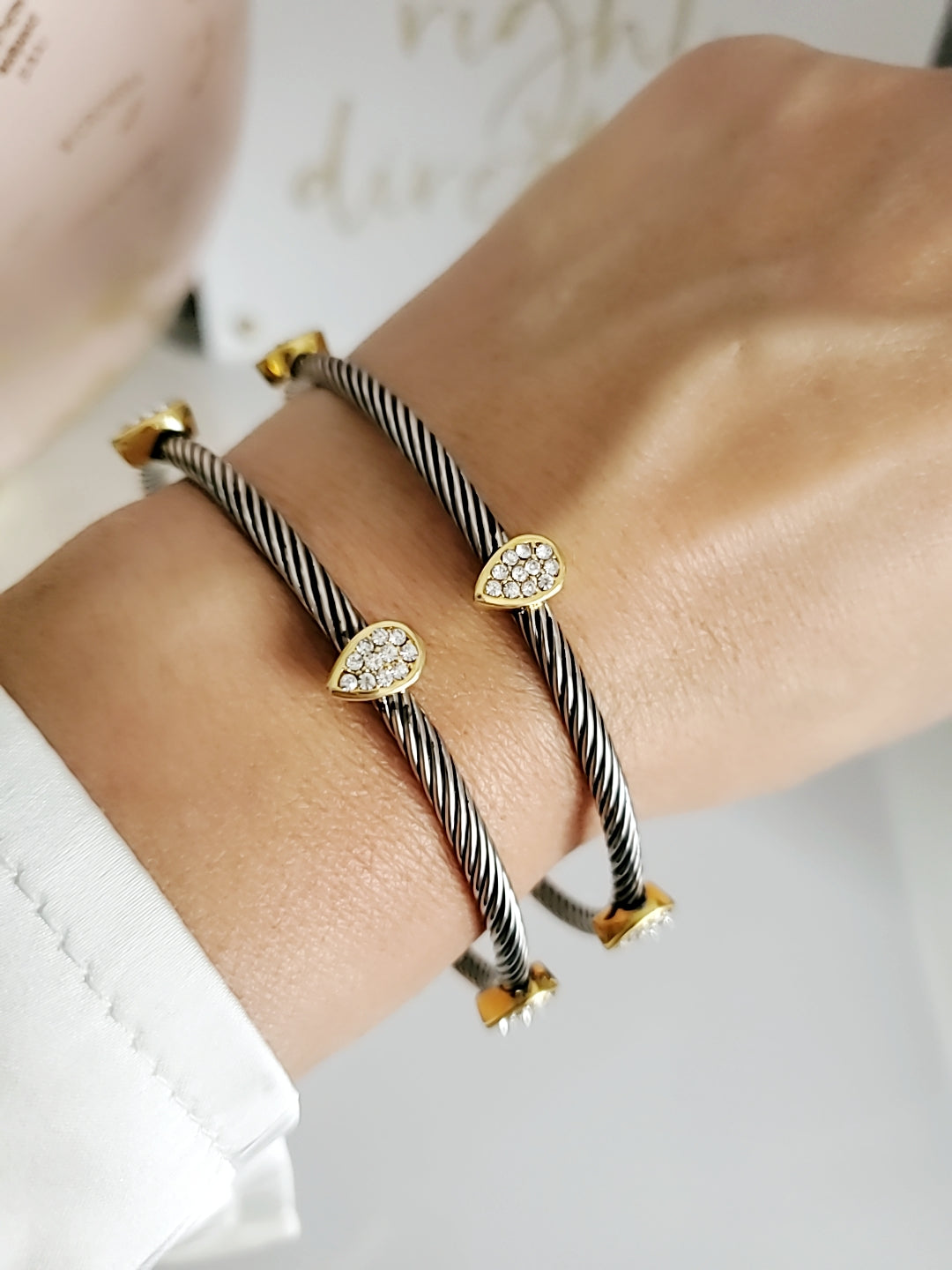 Wide Cable Bangle with Drop Accents featuring stainless steel and gold-filled materials, showcasing a modern design with elegant drop accents.