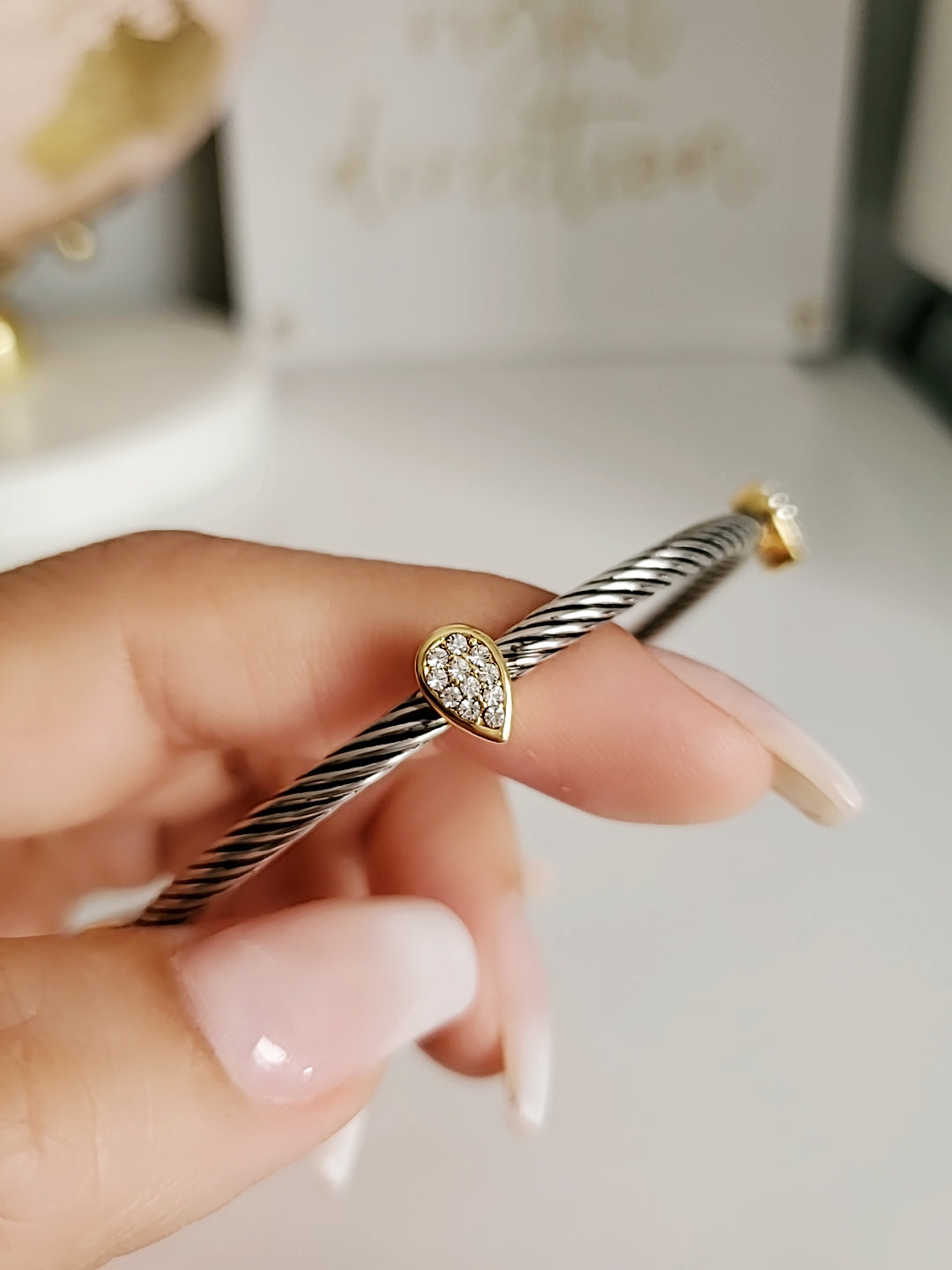 Wide Cable Bangle with Drop Accents featuring stainless steel and gold-filled materials, showcasing a modern design with elegant drop accents.