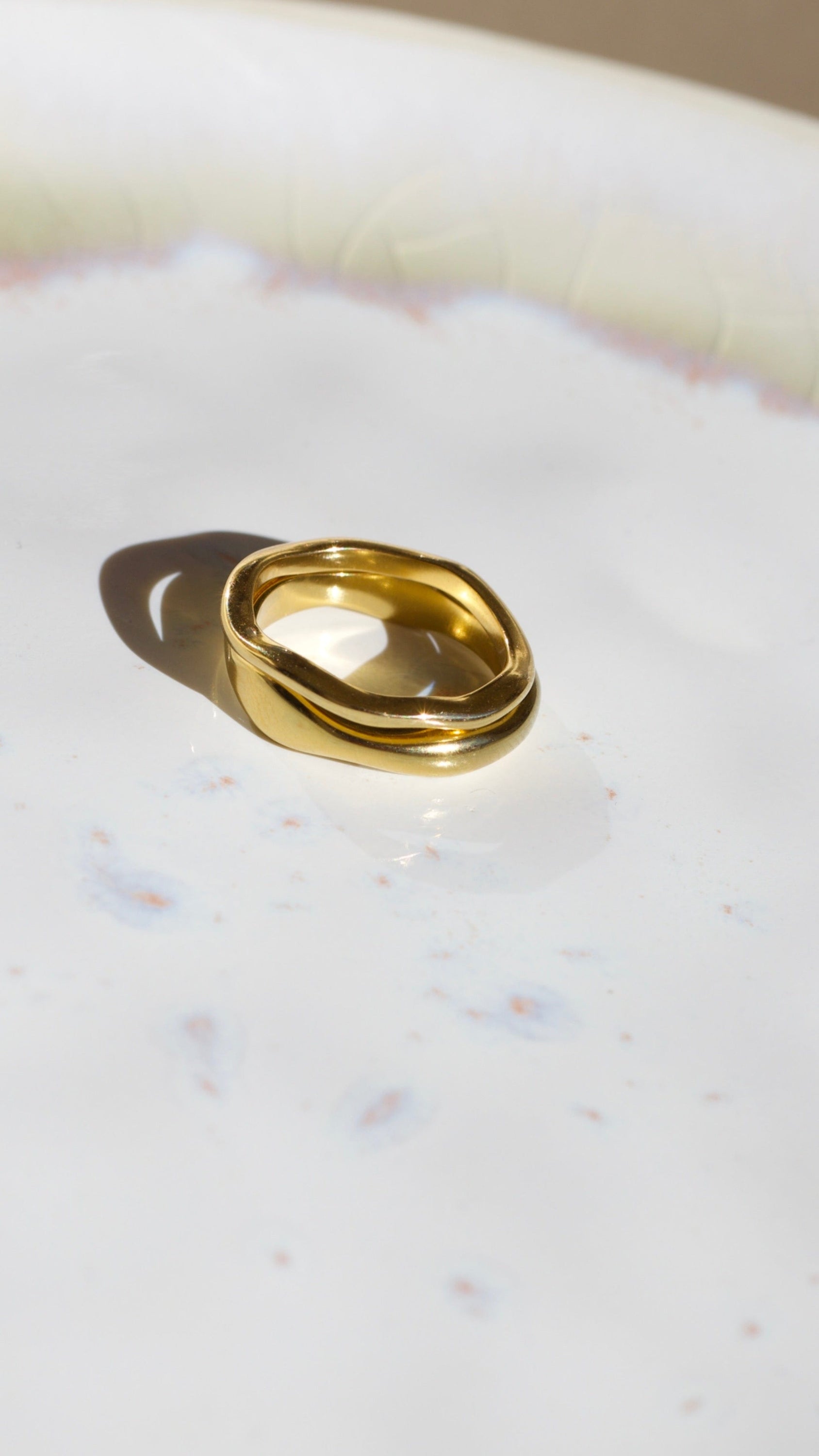 Elegant Winter Double Ring Gold made of titanium steel with 18k gold plating, showcasing a unique double ring design.