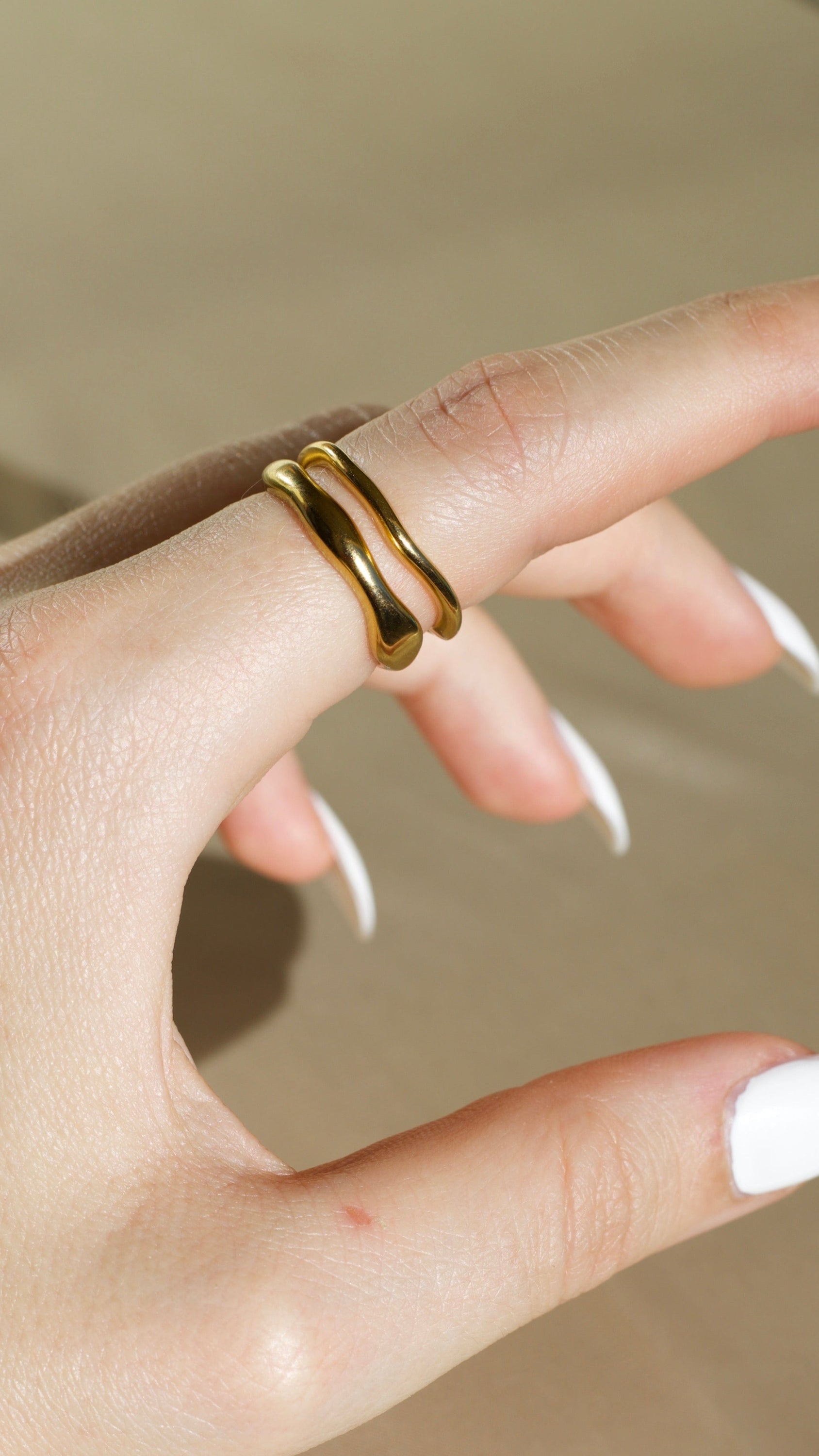 Elegant Winter Double Ring Gold made of titanium steel with 18k gold plating, showcasing a unique double ring design.