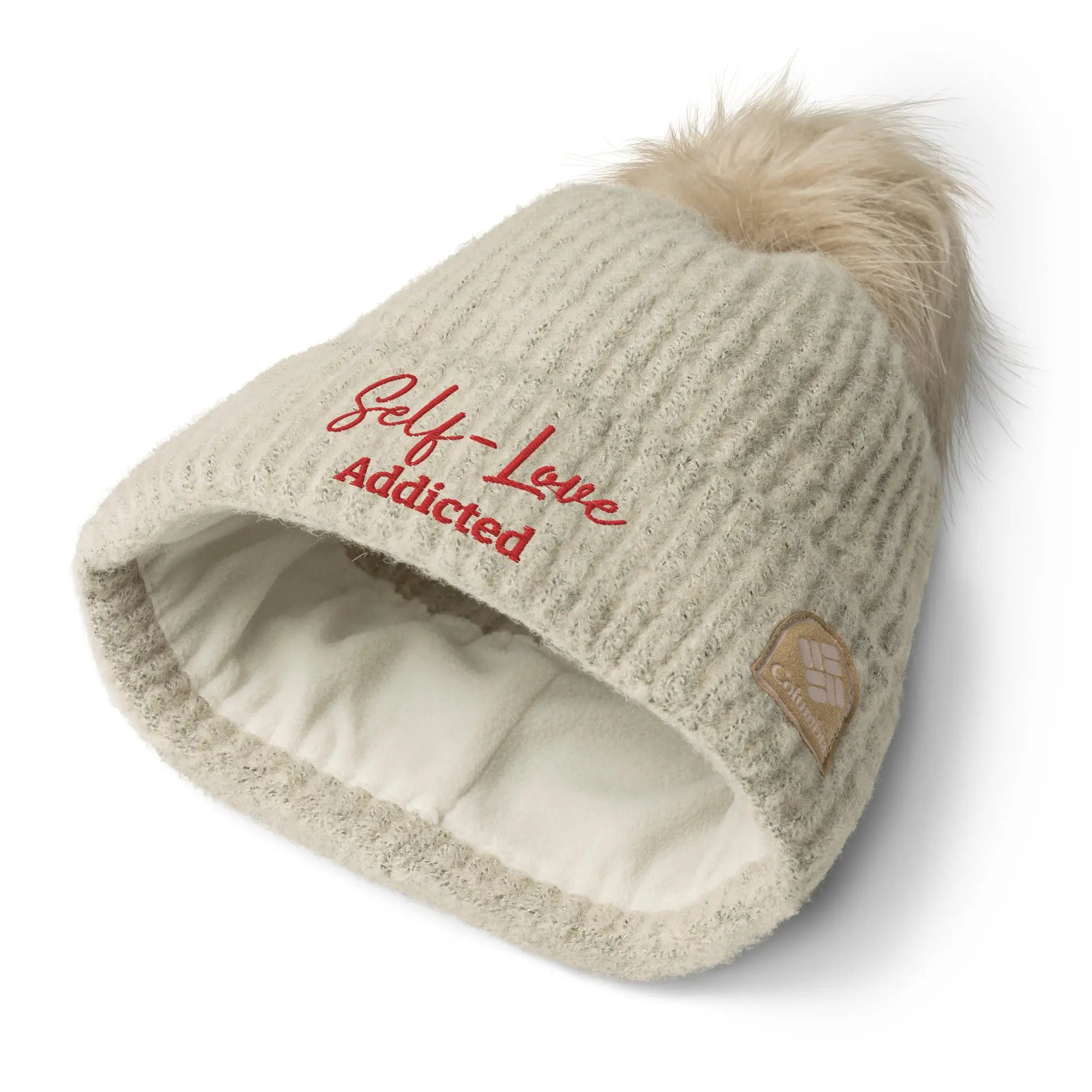 Cozy Columbia pom-pom beanie in winter, featuring fluffy pom on top and soft microfleece lining.