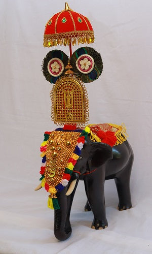 Handcrafted wooden elephant sculpture with Pooram settings, showcasing intricate carvings and elegant proportions.