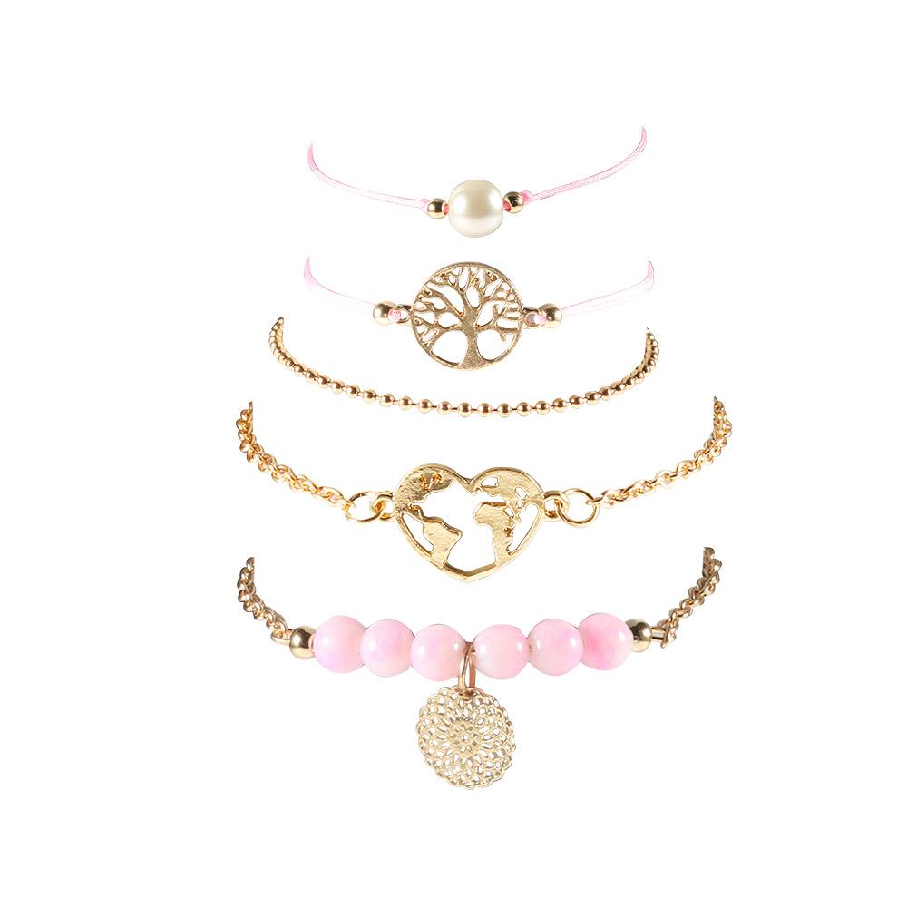 Women of The World Unite 5 Piece Bracelet Set featuring 14K gold plating, pink marble, filigree world pendant, and Tree of Life pendant.