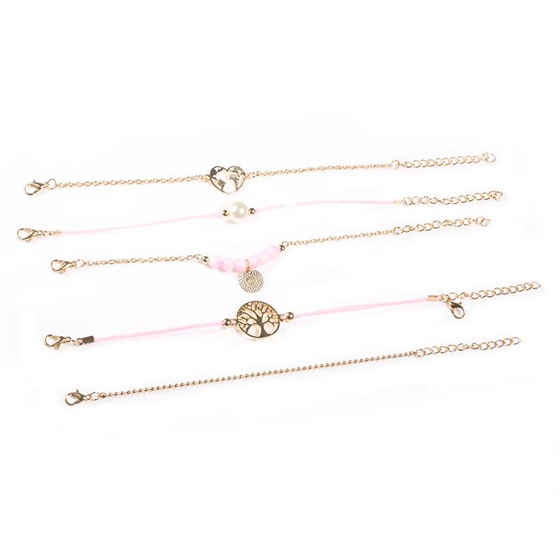 Women of The World Unite 5 Piece Bracelet Set featuring 14K gold plating, pink marble, filigree world pendant, and Tree of Life pendant.