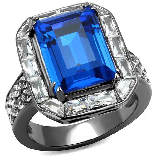 A stylish women's stainless steel ring featuring a Capri Blue synthetic crystal in an oblong design with an IP Light Black finish.