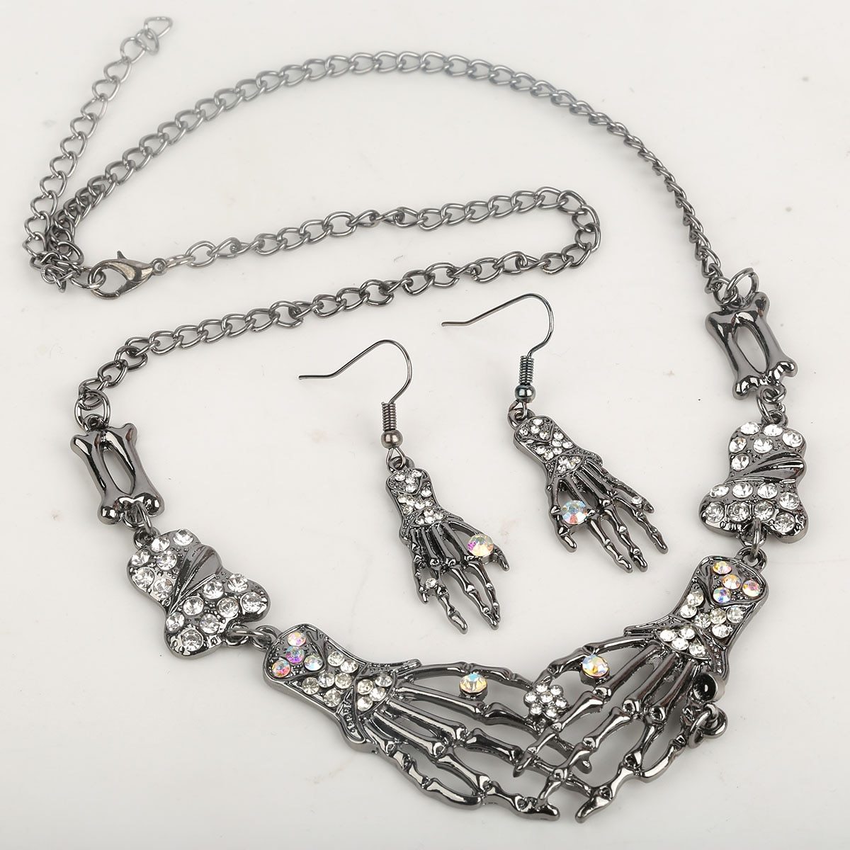 Women's Skeleton Hand Bone Skull Jewelry Set featuring an adjustable necklace and dangle earrings, perfect for Halloween parties.