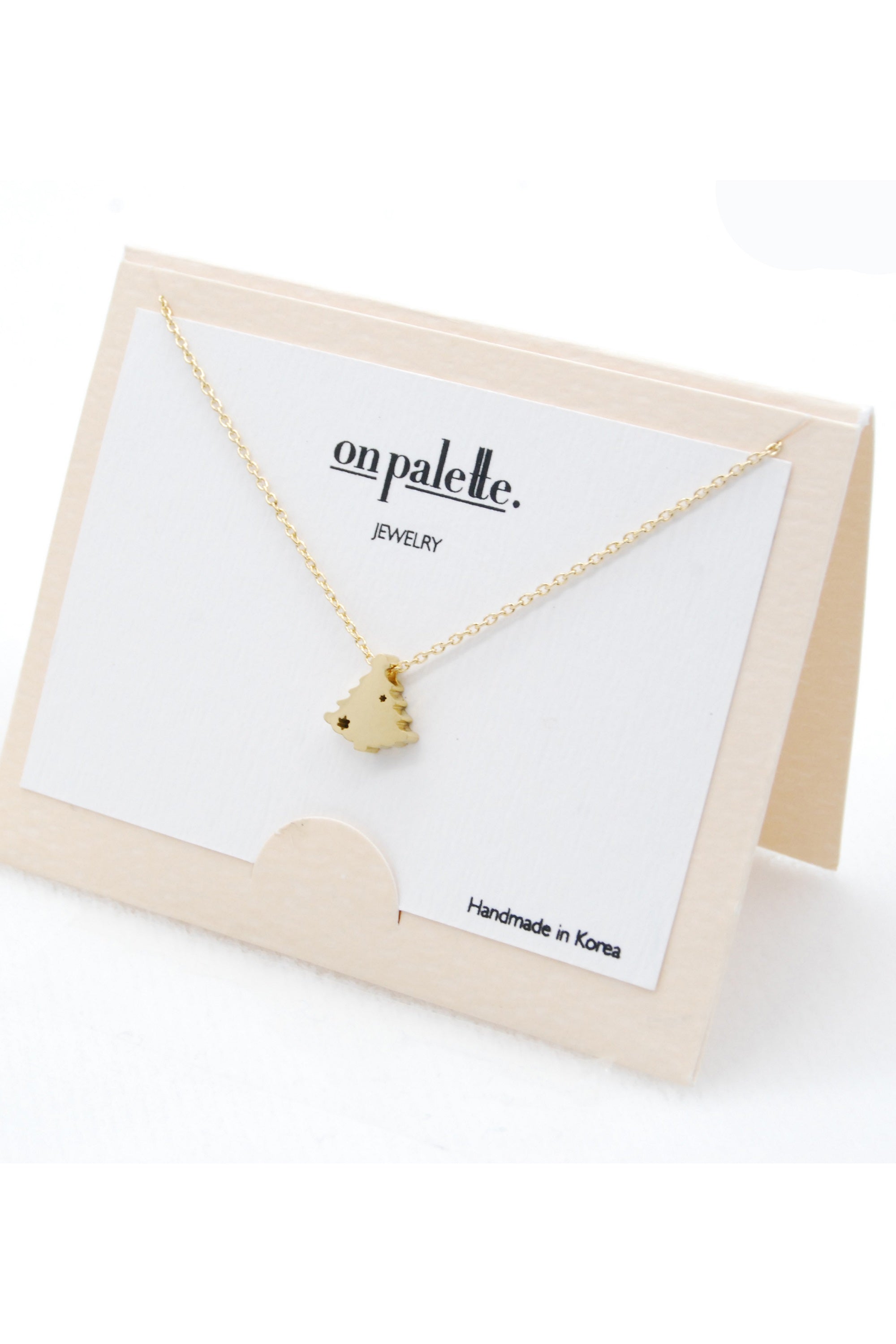 X-MAS Tree Pendant Necklace by DOBBI in various colors, showcasing a festive tree design made of stainless steel.