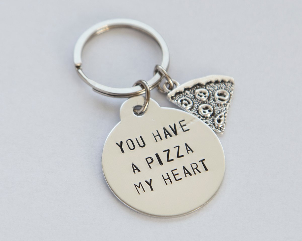 A hand-stamped stainless steel keychain with a round charm saying 'You have a pizza my heart', perfect for pizza lovers.