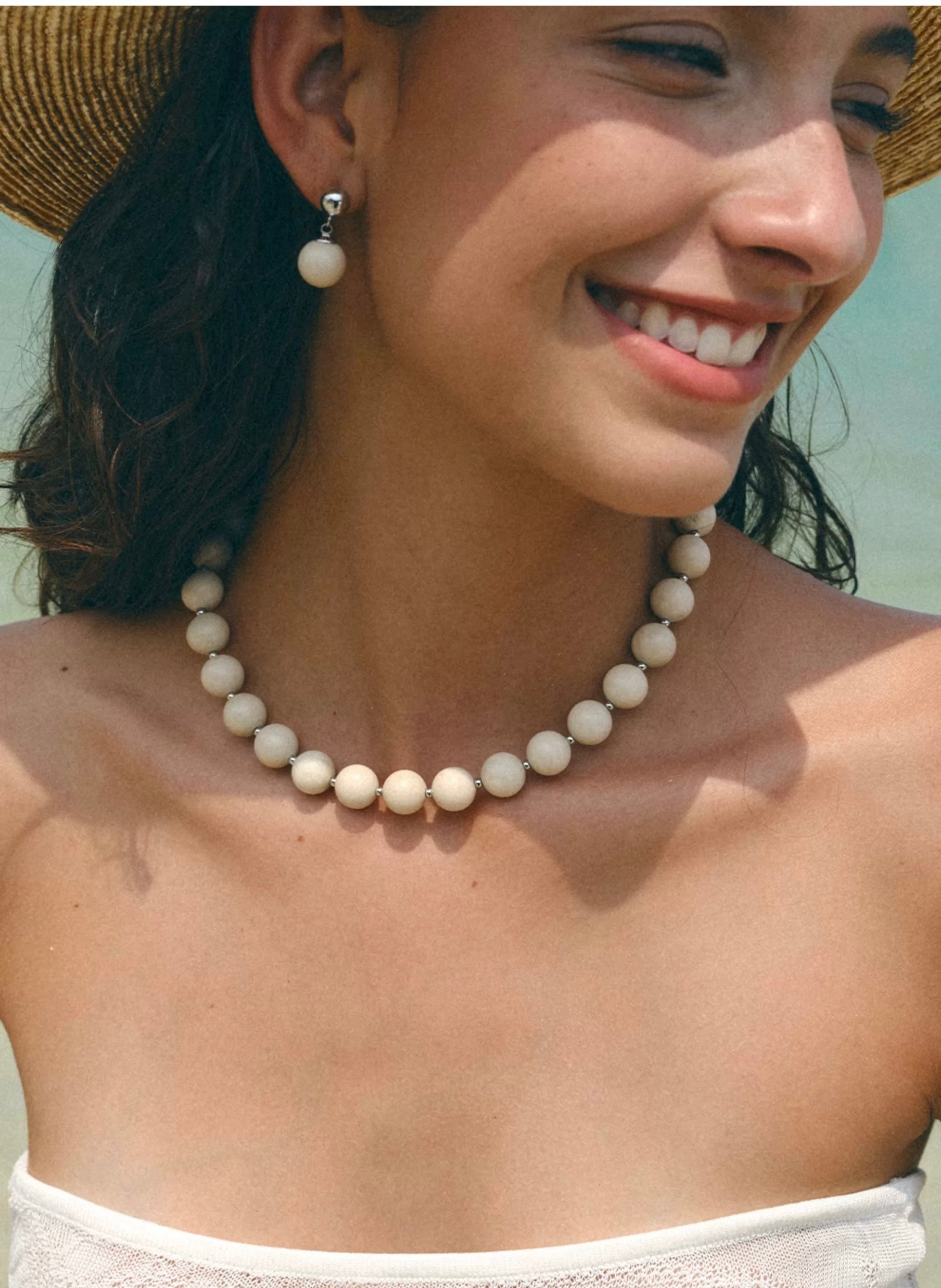 A beautiful Zen Harmony Tranquil White Fossil Necklace featuring natural white fossil stones, elegantly designed with 12mm beads.