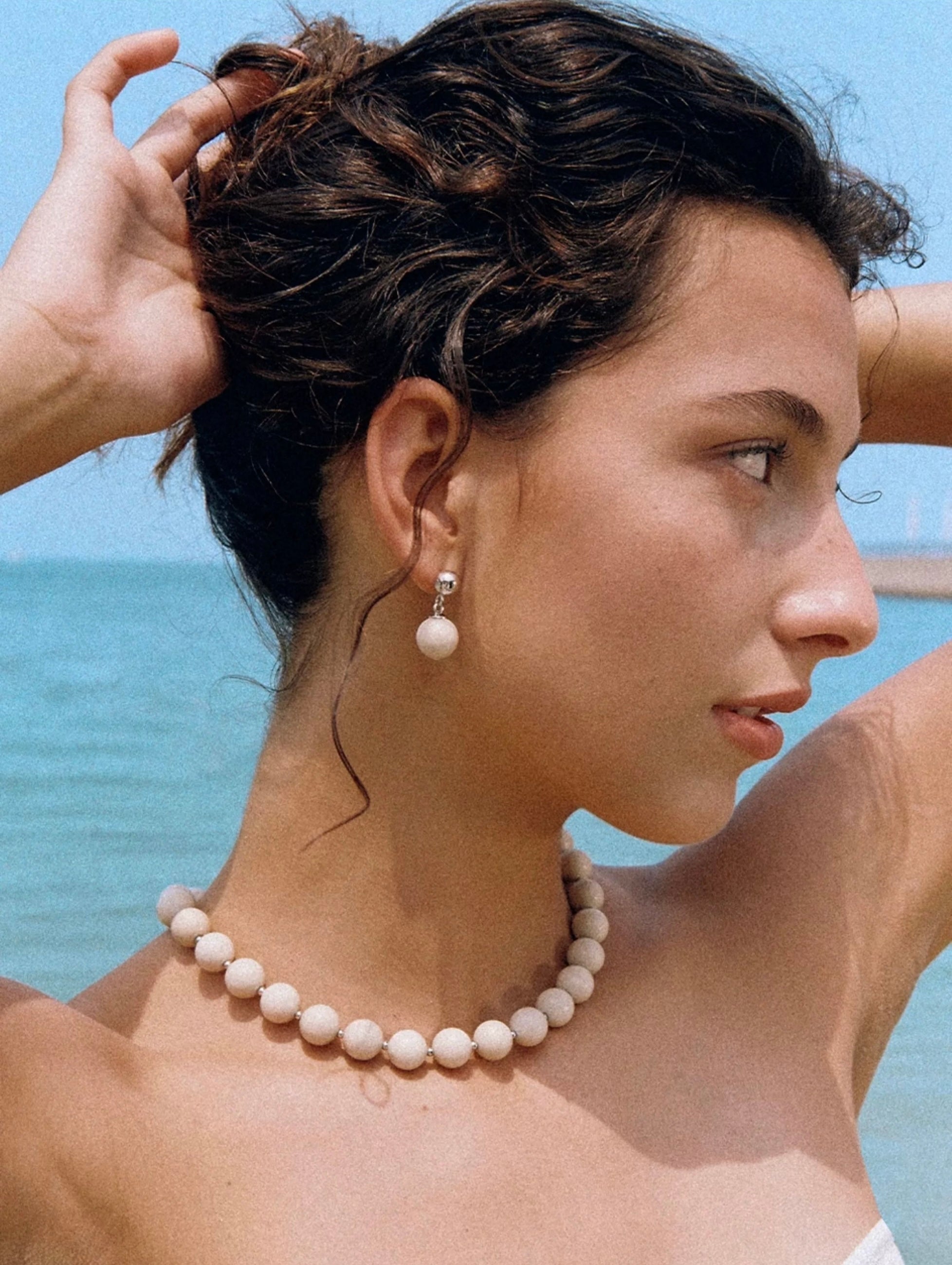 A beautiful Zen Harmony Tranquil White Fossil Necklace featuring natural white fossil stones, elegantly designed with 12mm beads.
