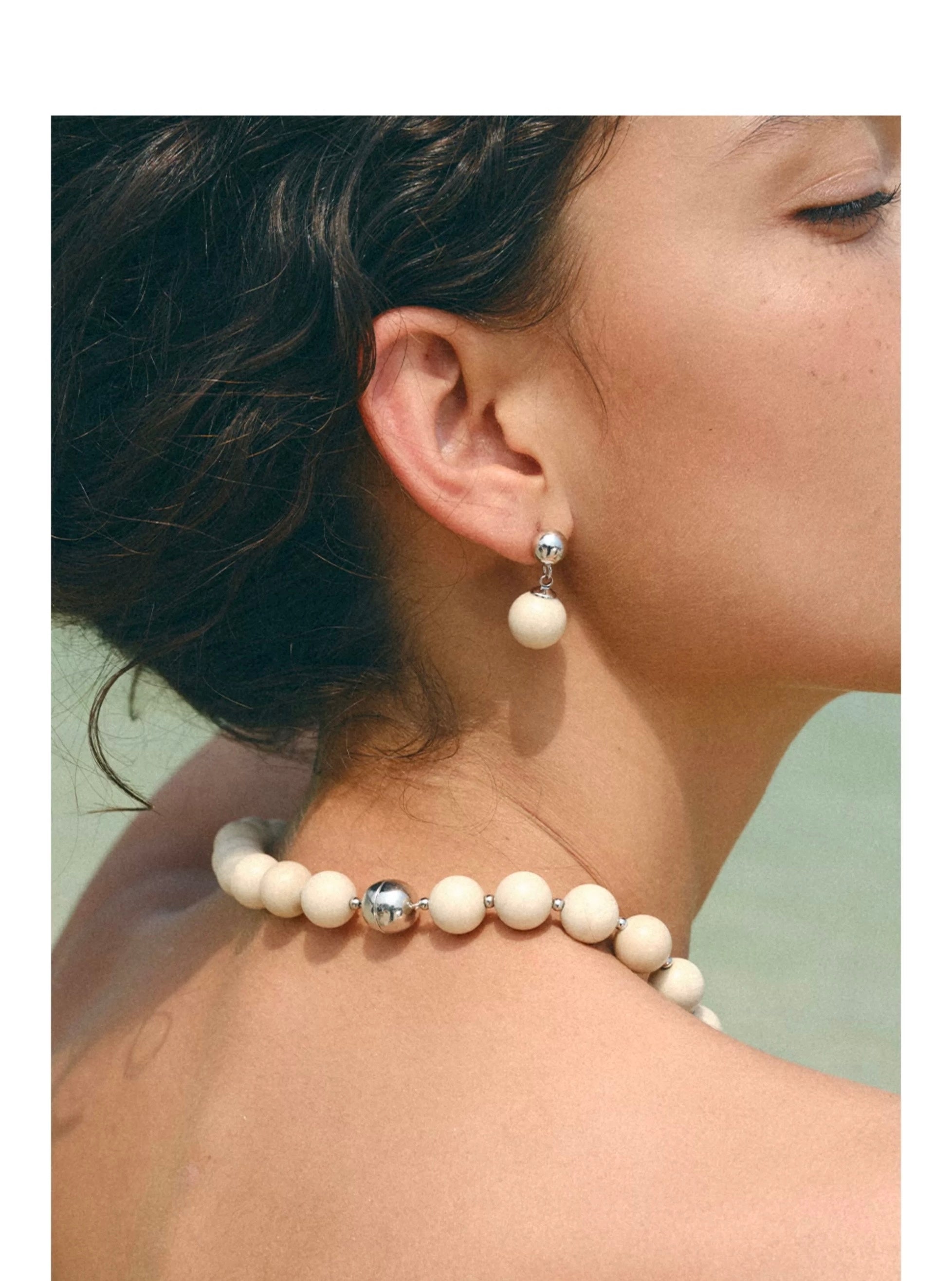 A beautiful Zen Harmony Tranquil White Fossil Necklace featuring natural white fossil stones, elegantly designed with 12mm beads.