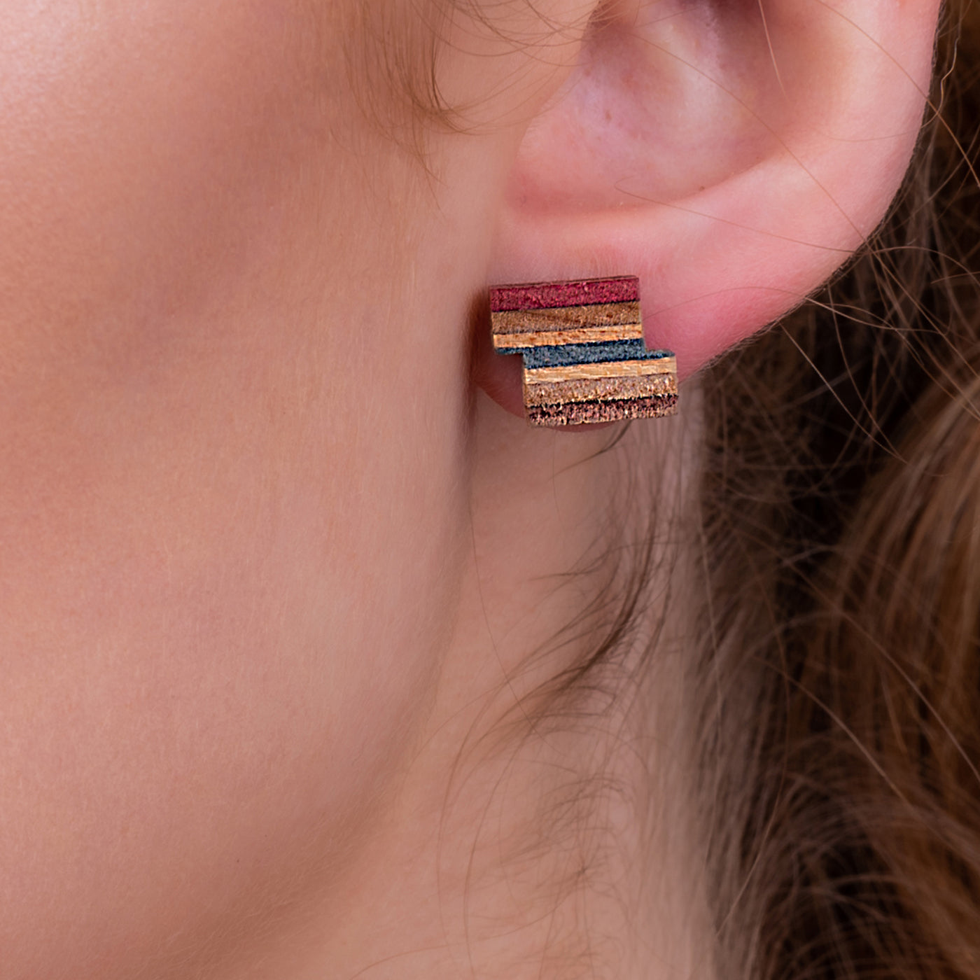 Handcrafted Zig Recycled Skateboard Stud Earrings showcasing unique patterns and colors from reclaimed skateboards.
